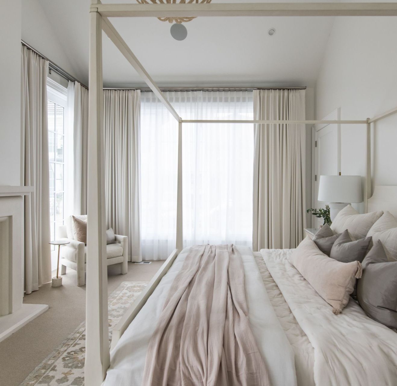 Custom sheer drapery creating privacy and softness in luxury bedroom