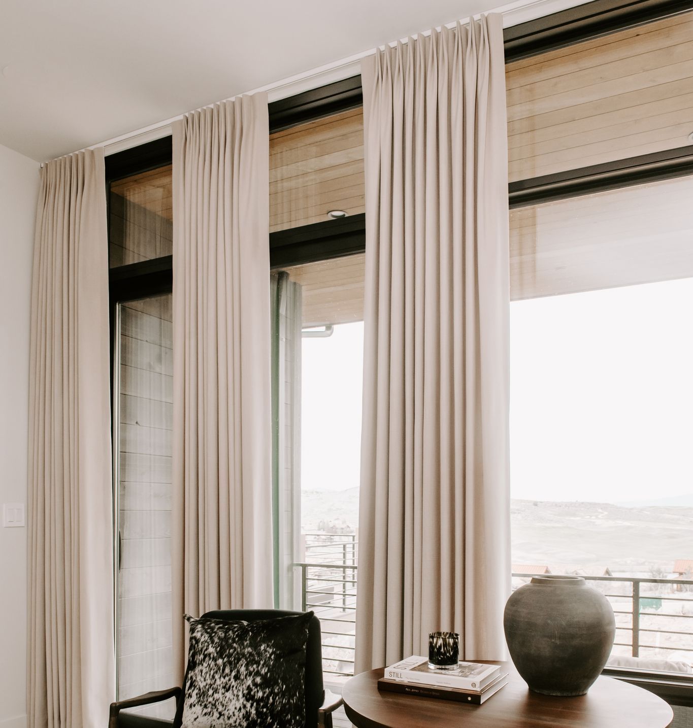 Custom pleated drapery with decorative hardware in luxury home
