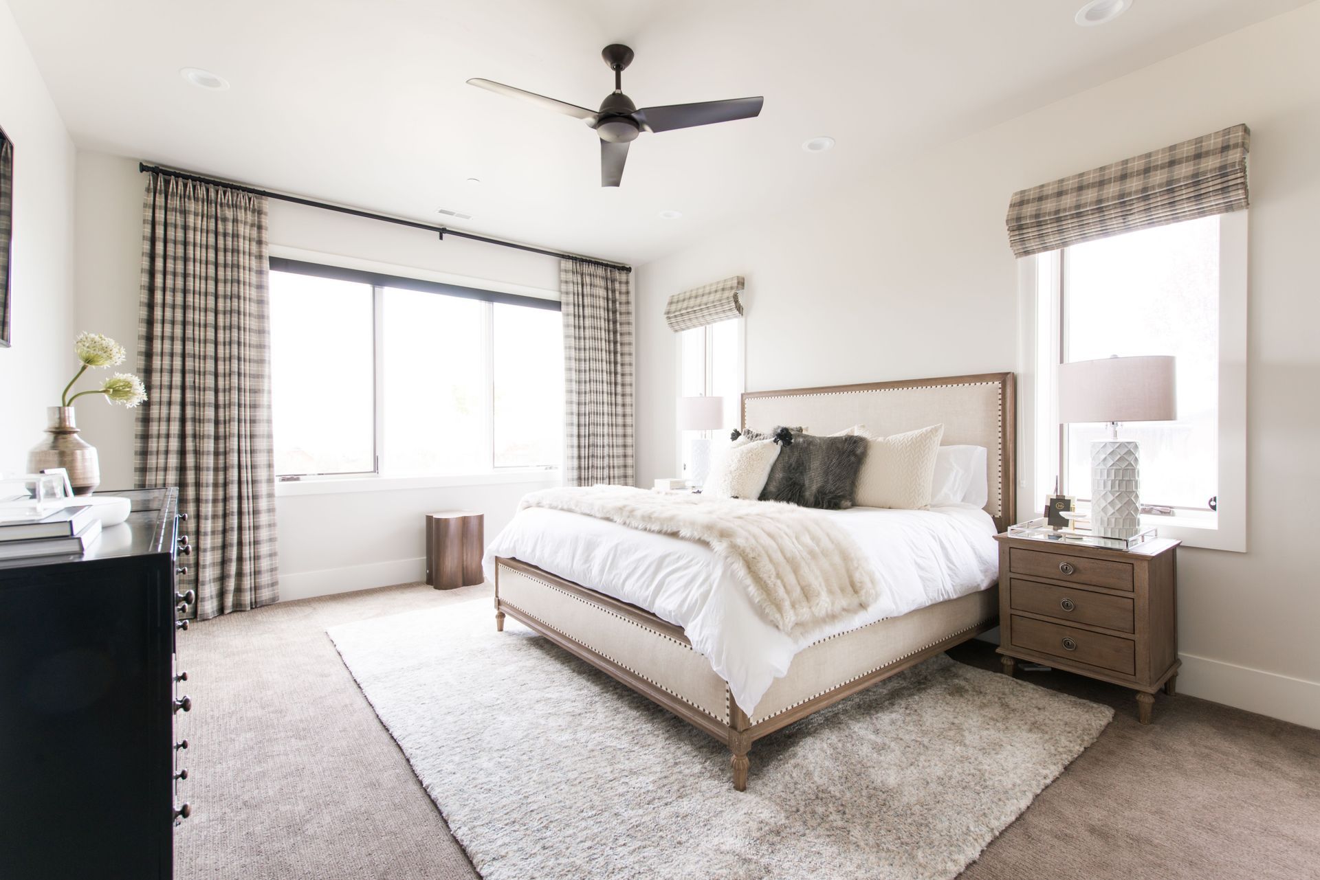 Custom Roman shades and drapery in luxury primary bedroom