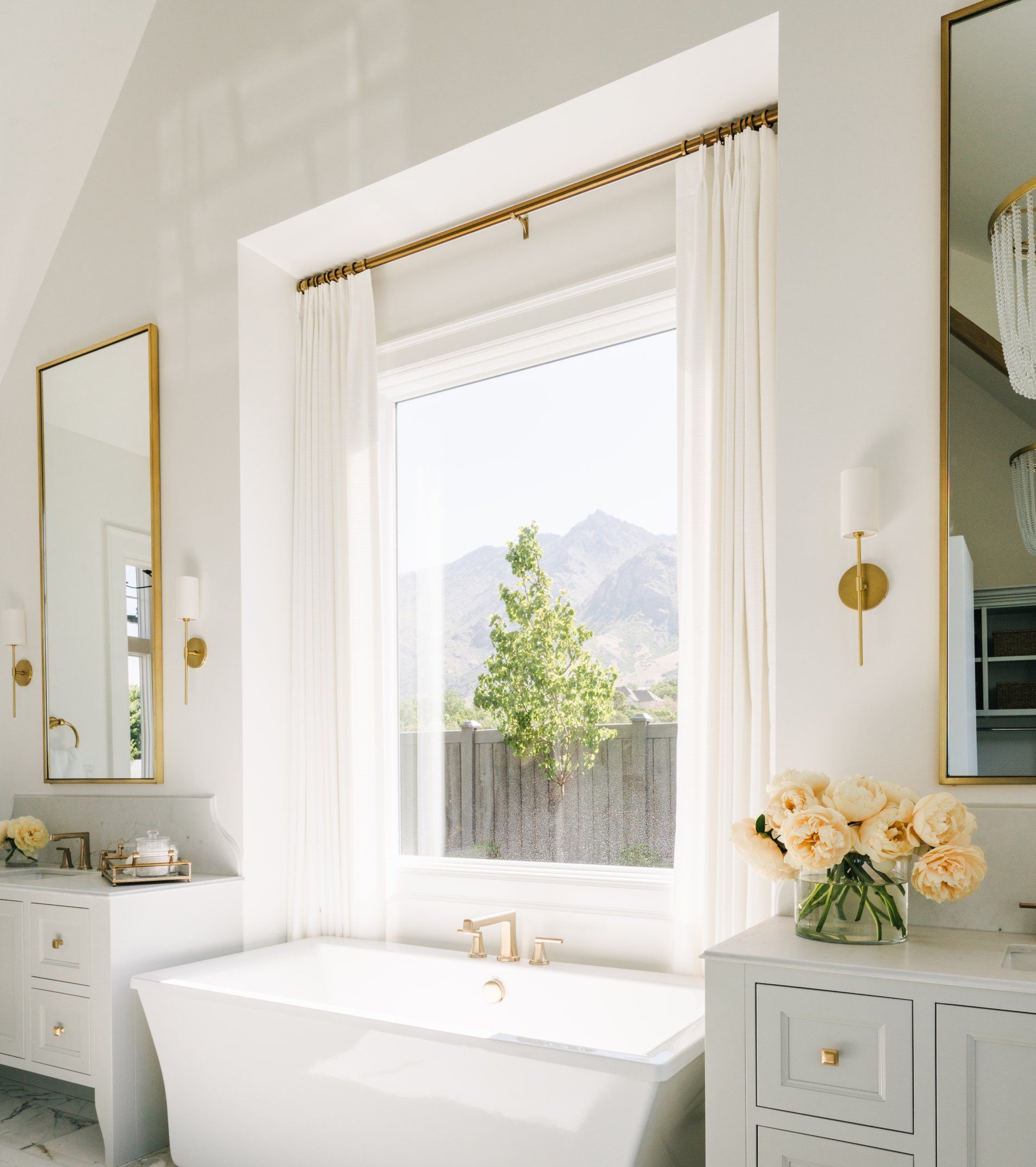 Custom white drapery with decorative hardware in luxury home