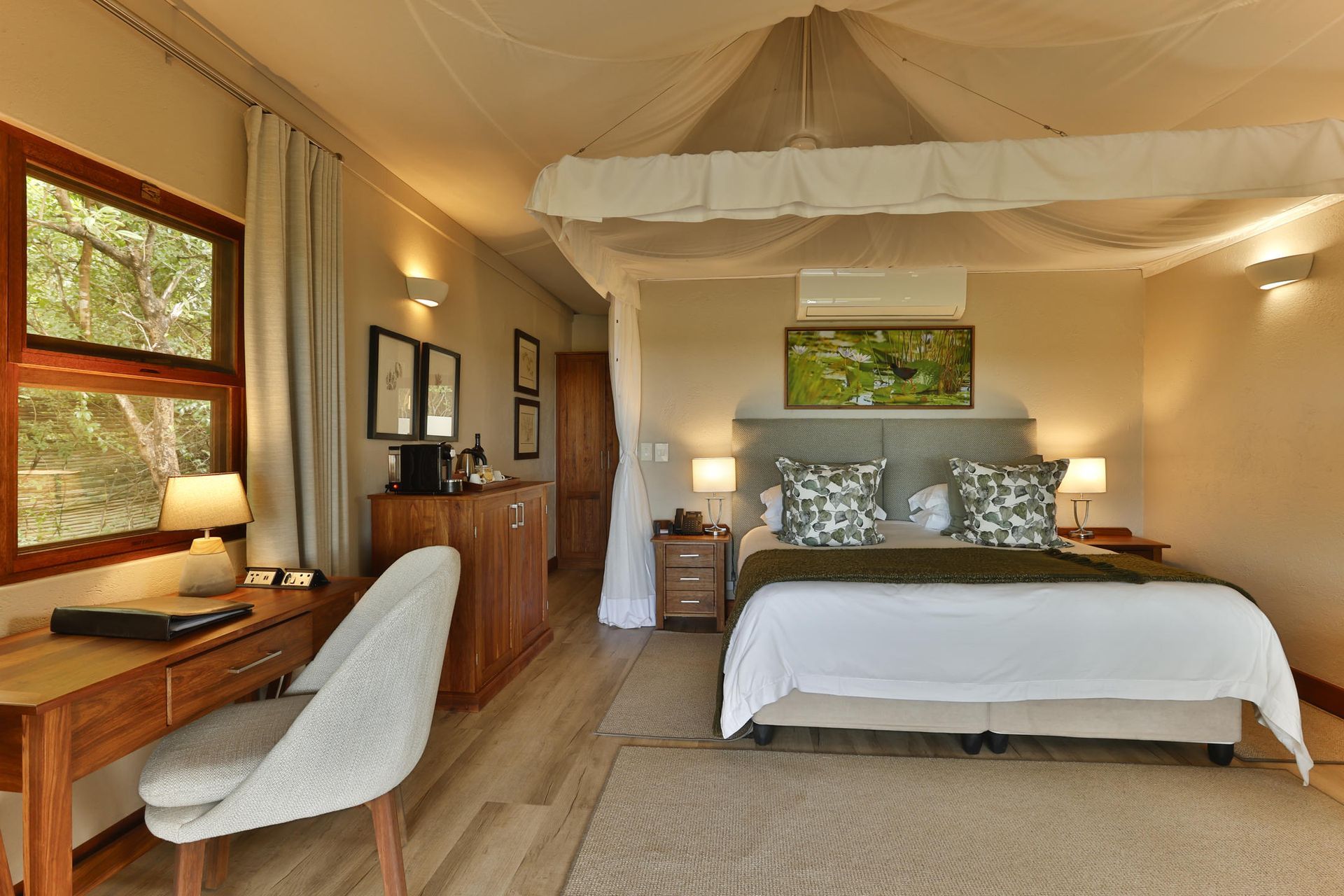 Bedroom with wooden furniture, large bed, desk, and window with a view.