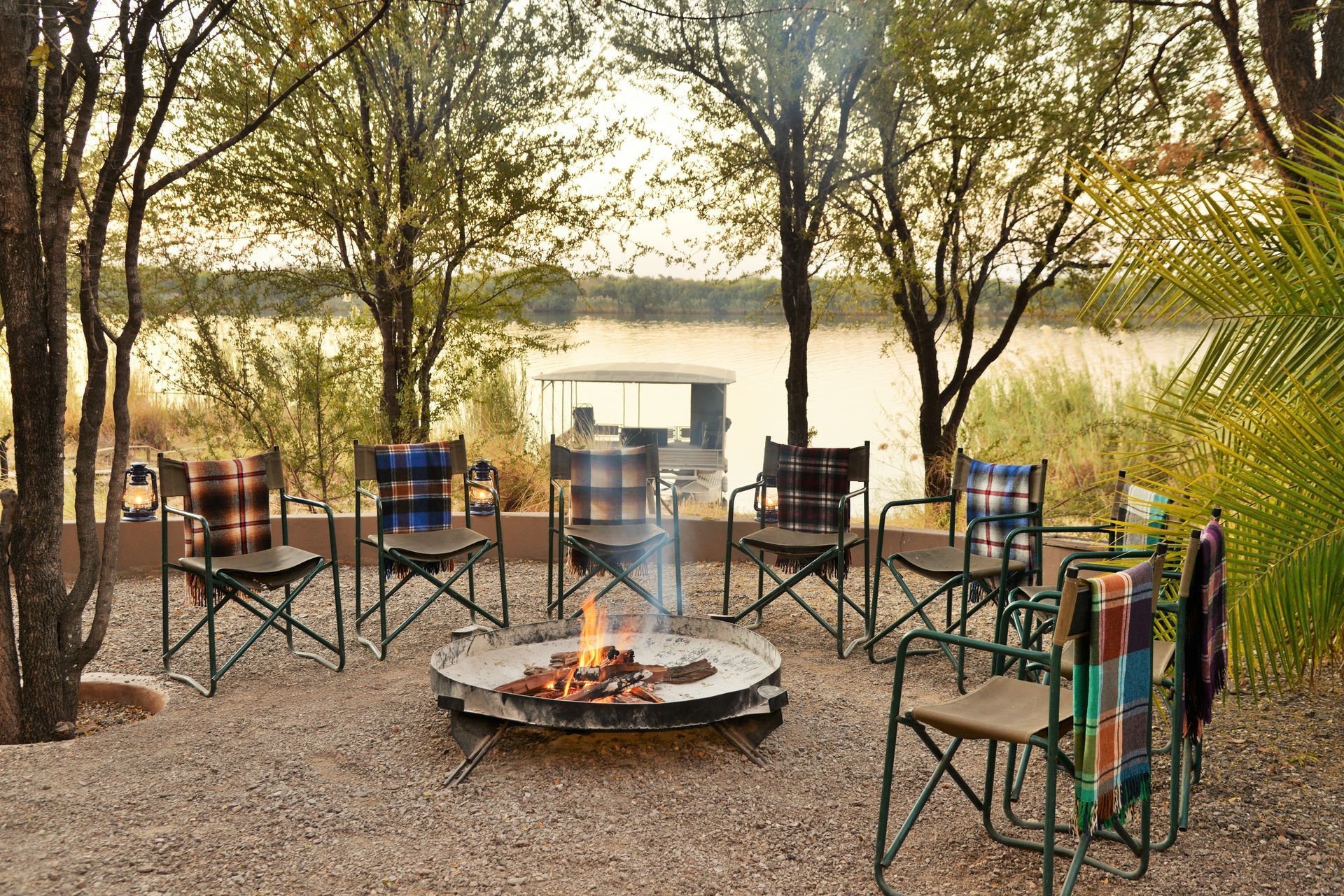 A group of chairs are sitting around a fire pit.