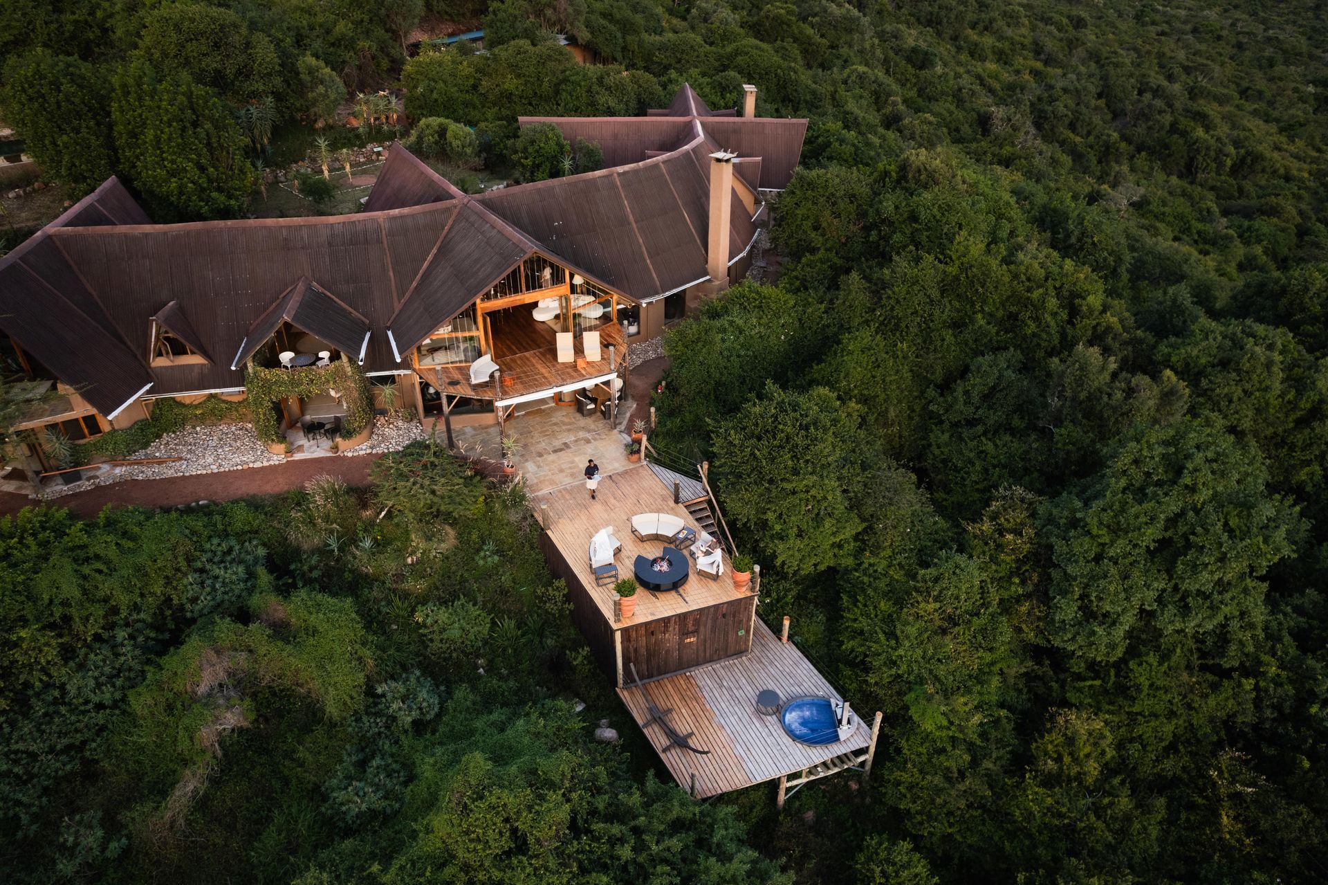 Balcony with mountain view, round table with chairs, lounge seating.