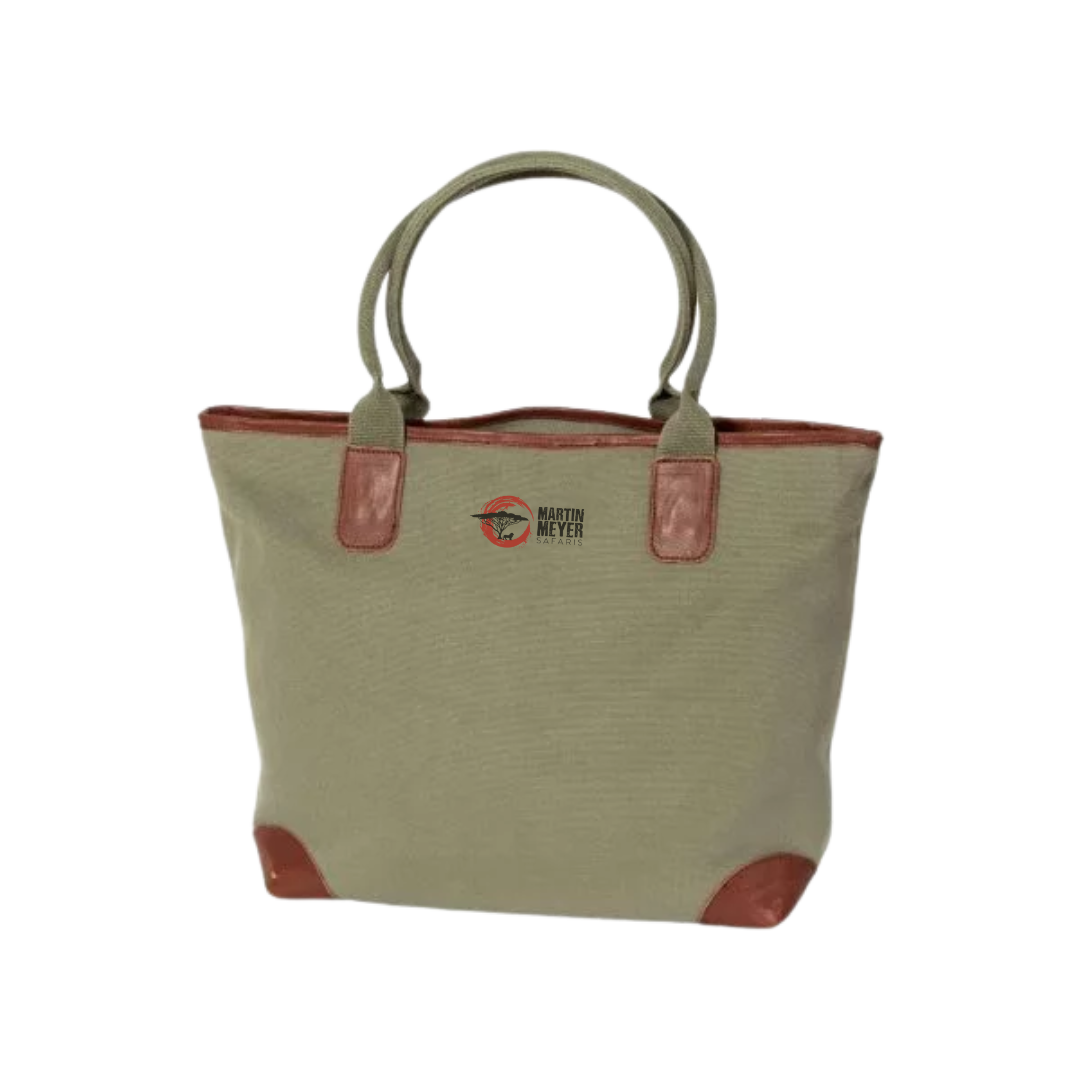 Tan canvas tote bag with brown leather accents and handles.