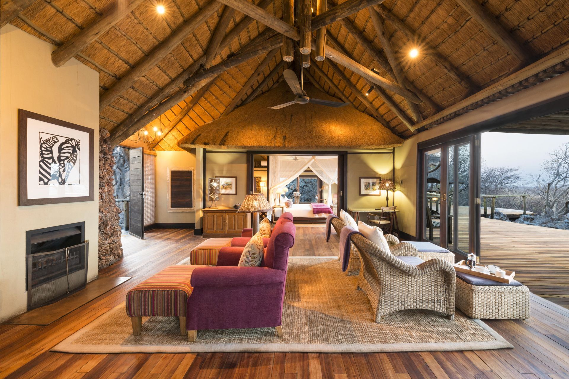 A living room filled with furniture and a thatched roof. Namibia Safari