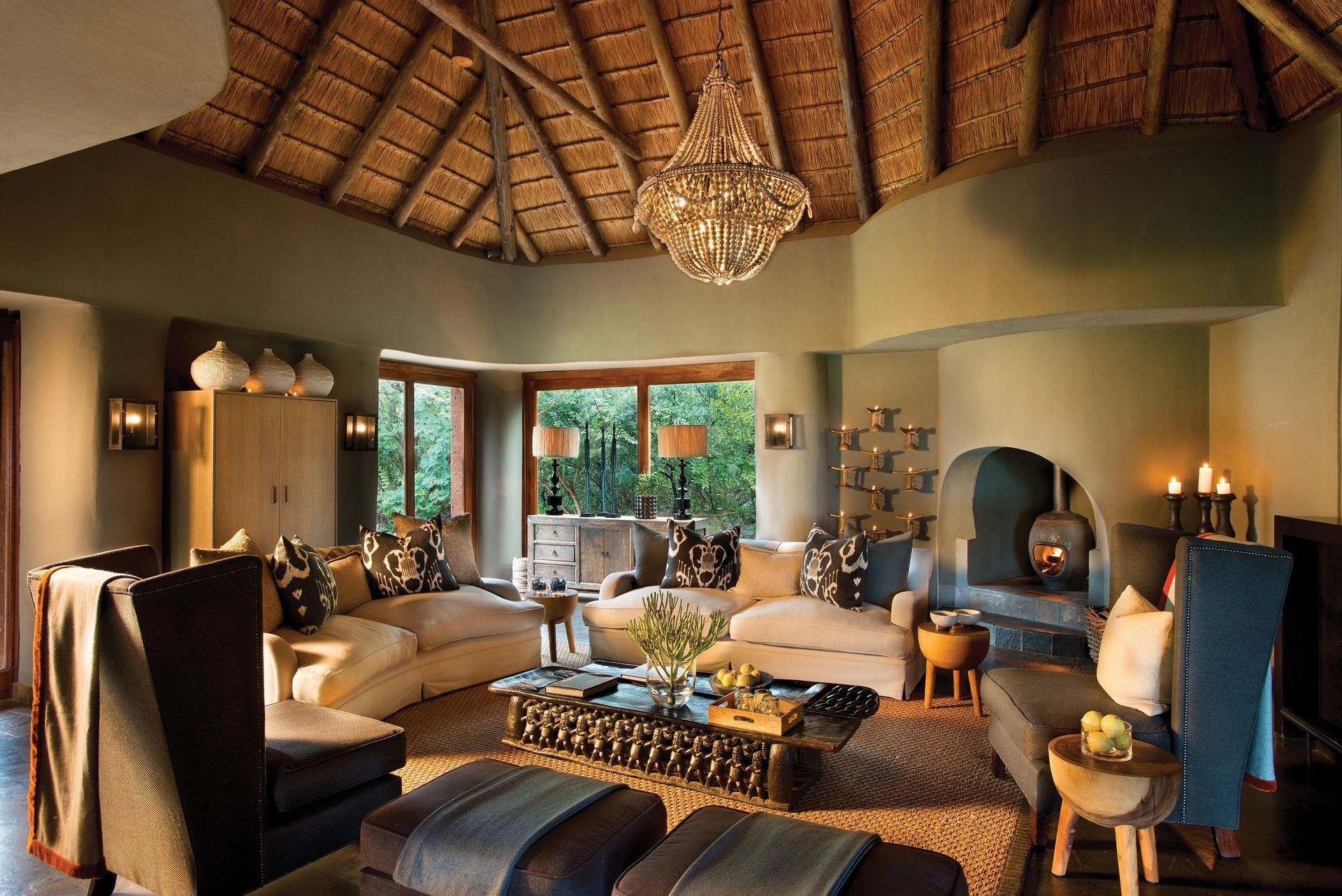 A living room with a thatched roof and lots of furniture Malaria Free Safari Destinations