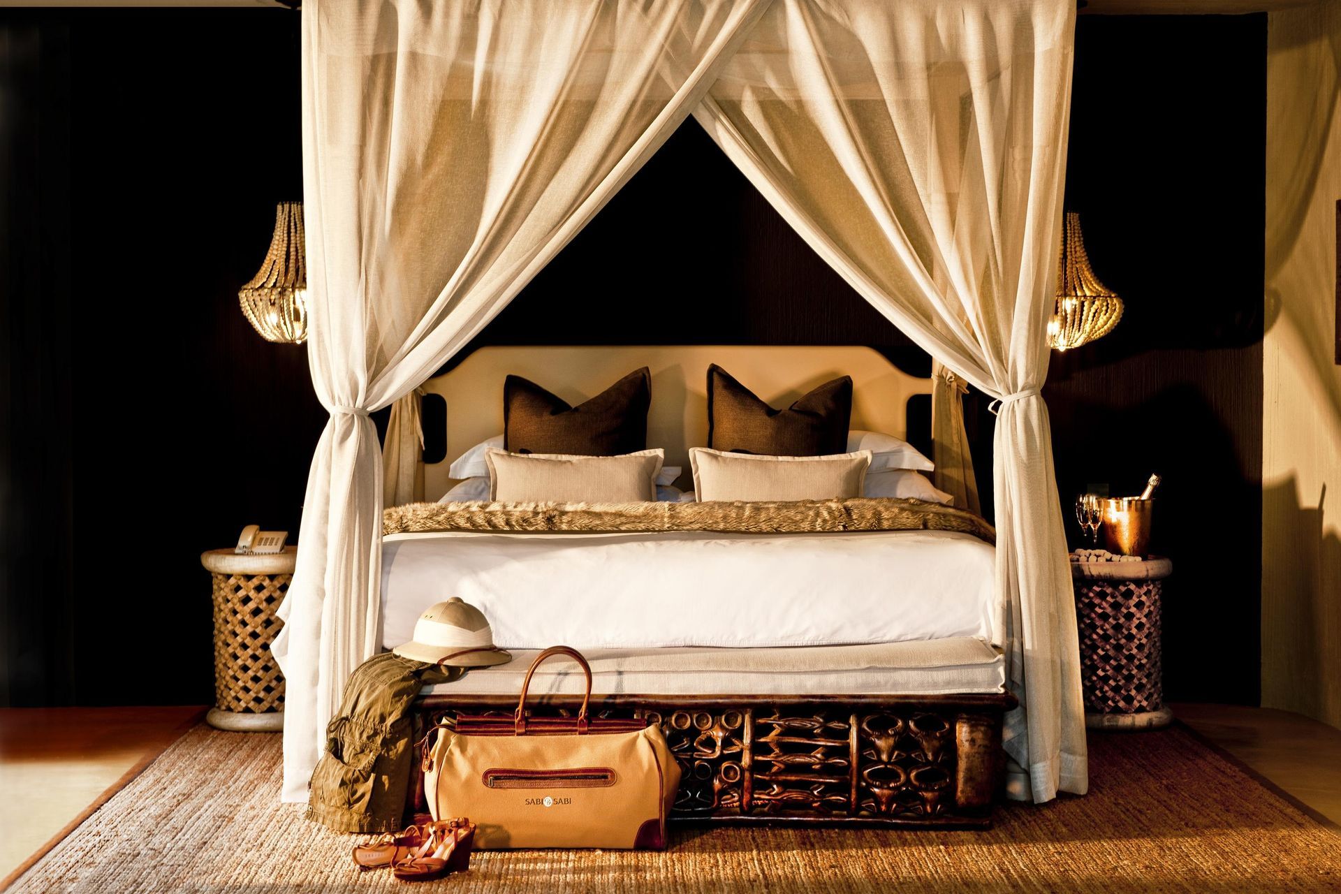 A bedroom with a canopy bed and a trunk