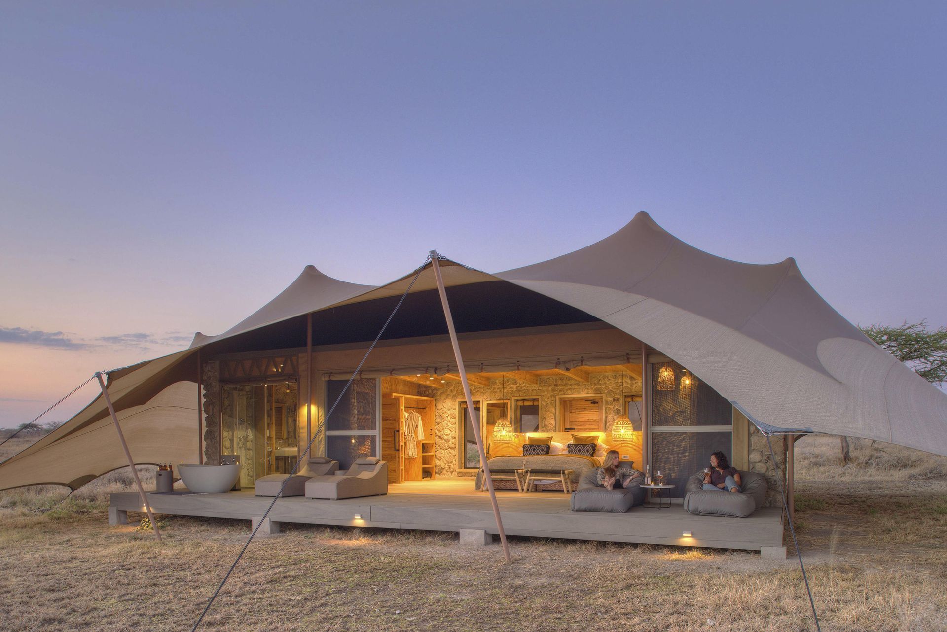A large tent is sitting in the middle of a desert.