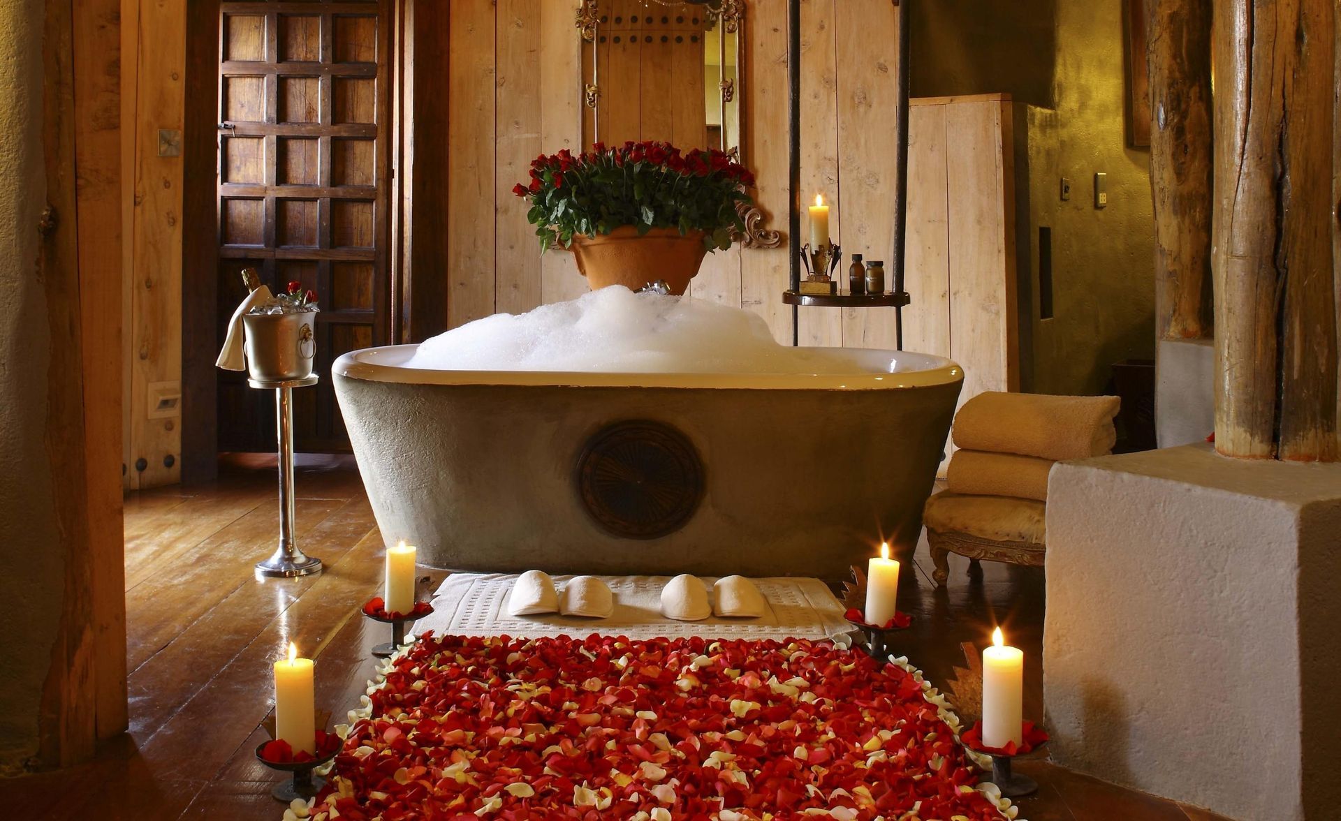 A bathtub filled with foam and candles in a bathroom Ngorongoro Crater