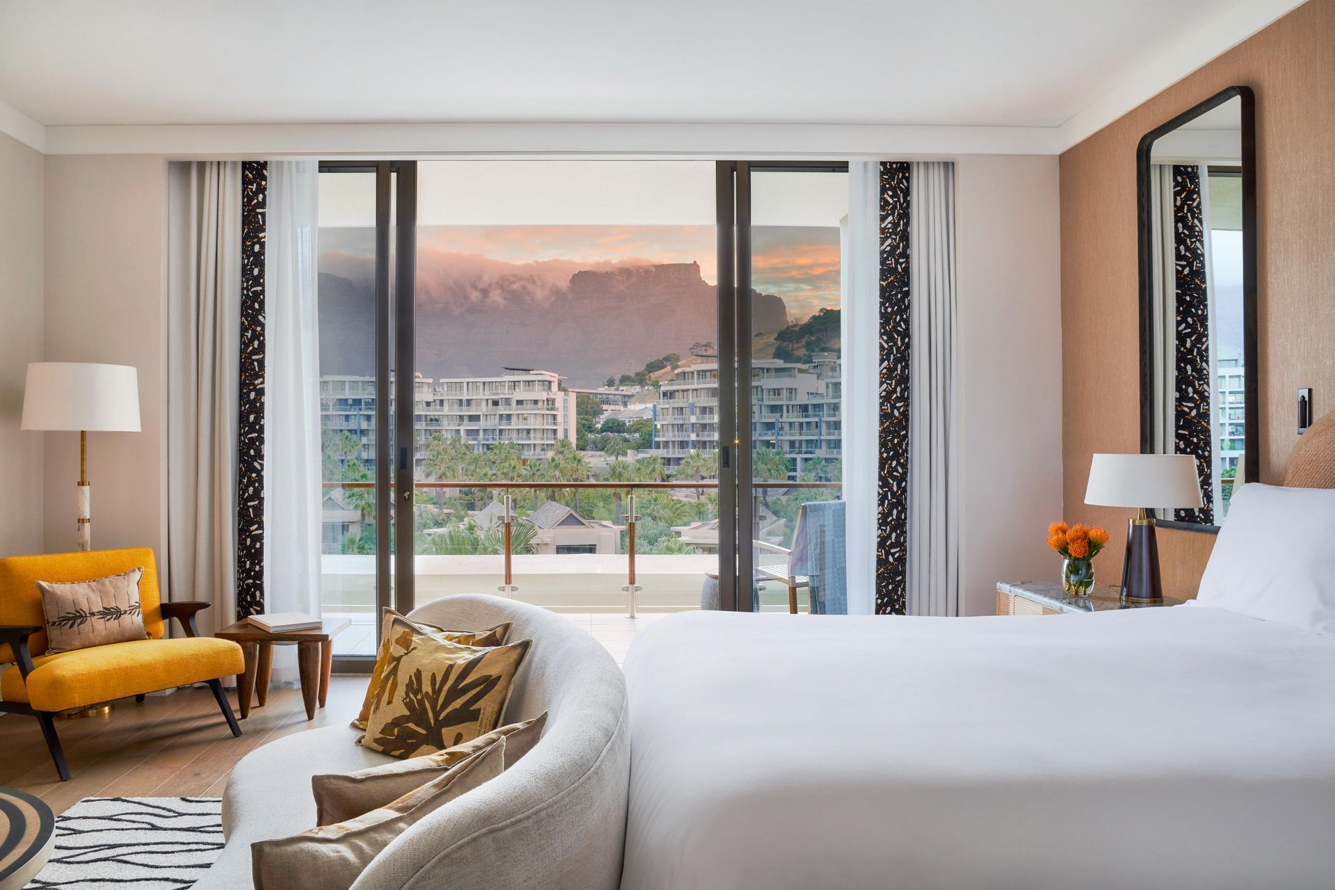 A hotel room with a king size bed and a balcony