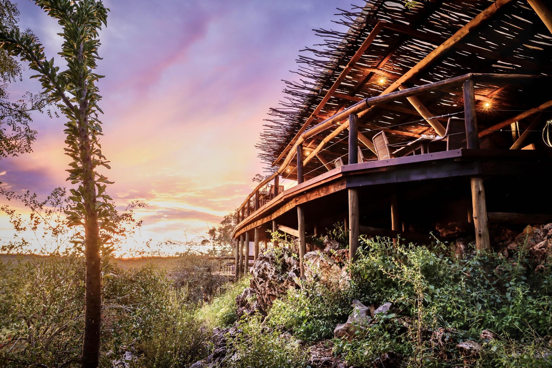 A wooden bridge over a river with a sunset in the background Namibia Safari