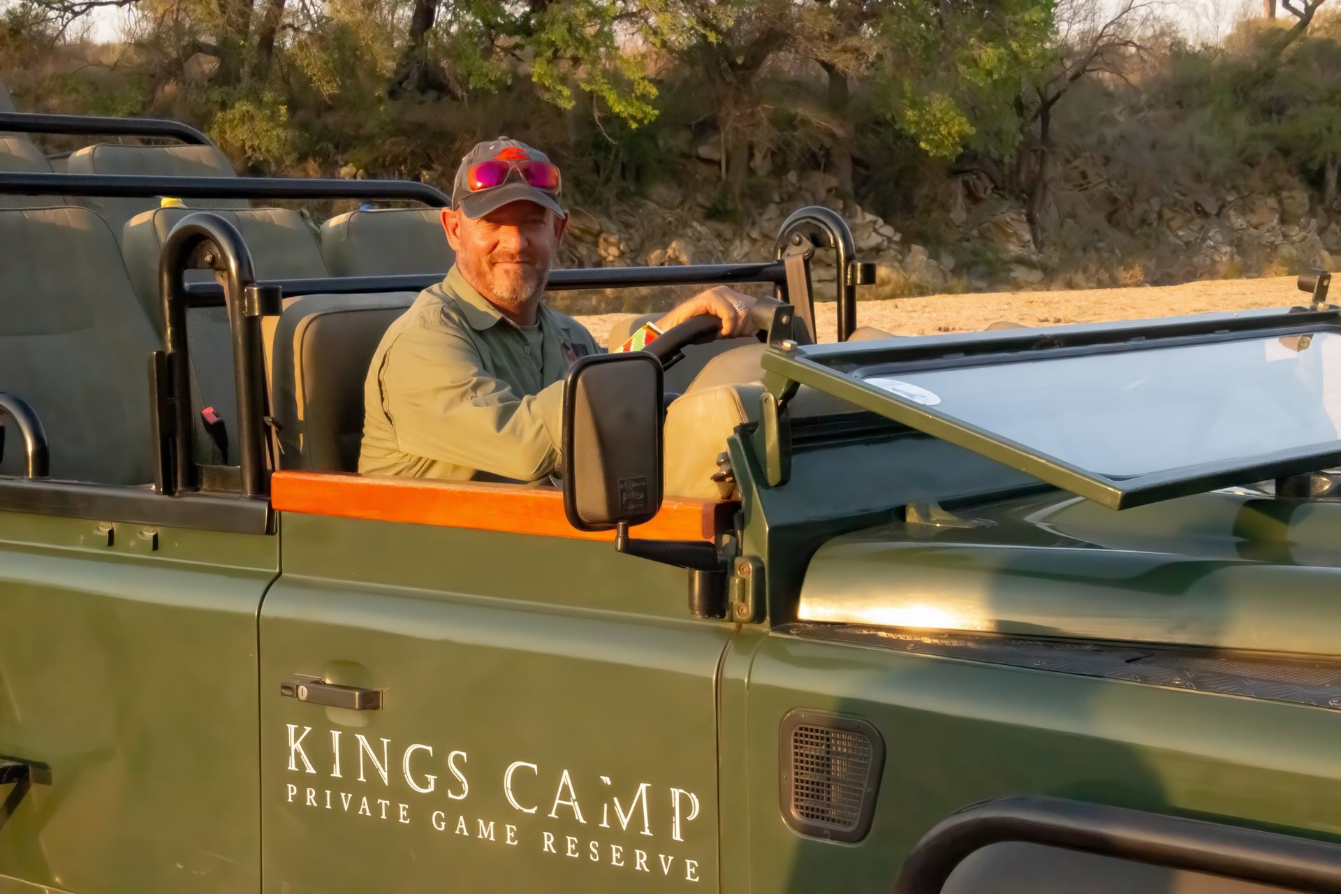 Martin Meyer Private Guide is sitting in the driver 's seat of a kings camp vehicle .