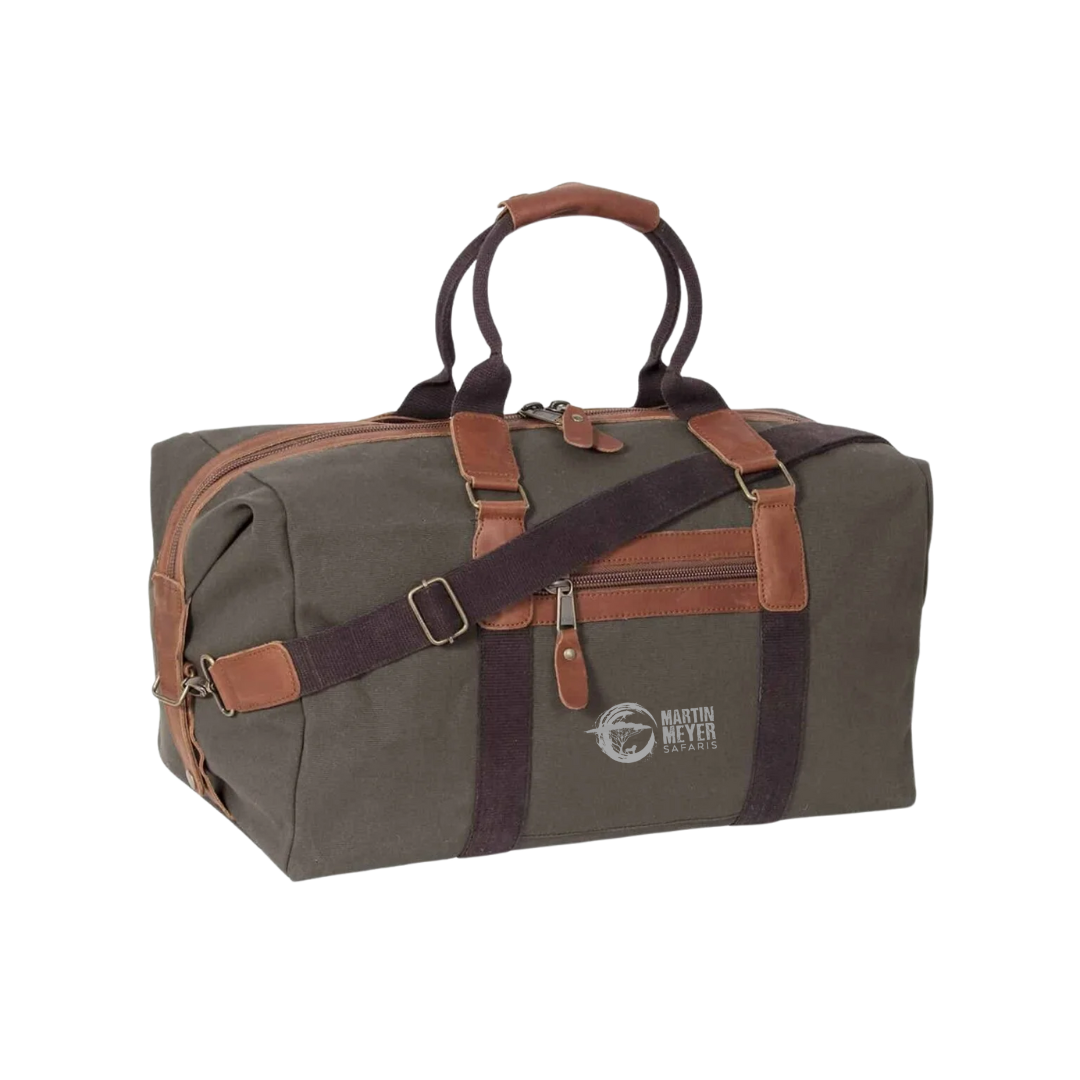Green canvas duffel bag with brown leather accents and straps.