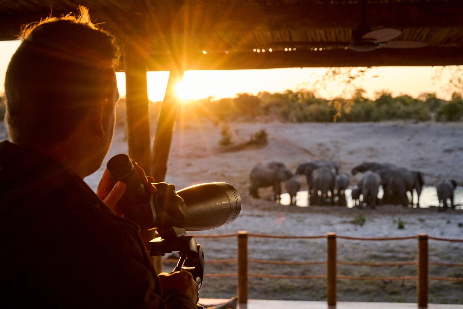 A man at Leroo LaTau taking pictures on a photographic safari