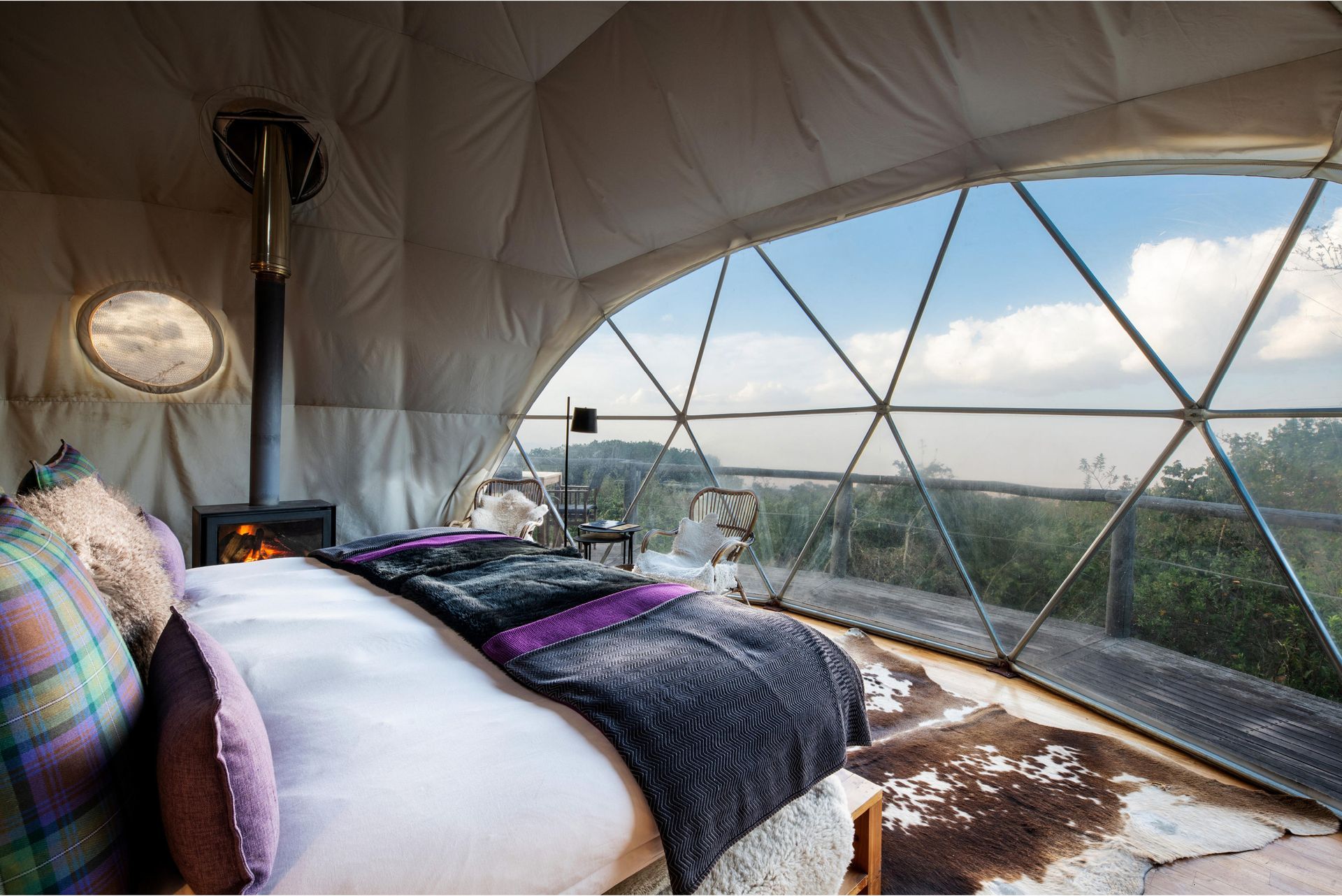 A bedroom with a large bed and a large window Ngorongoro Crater