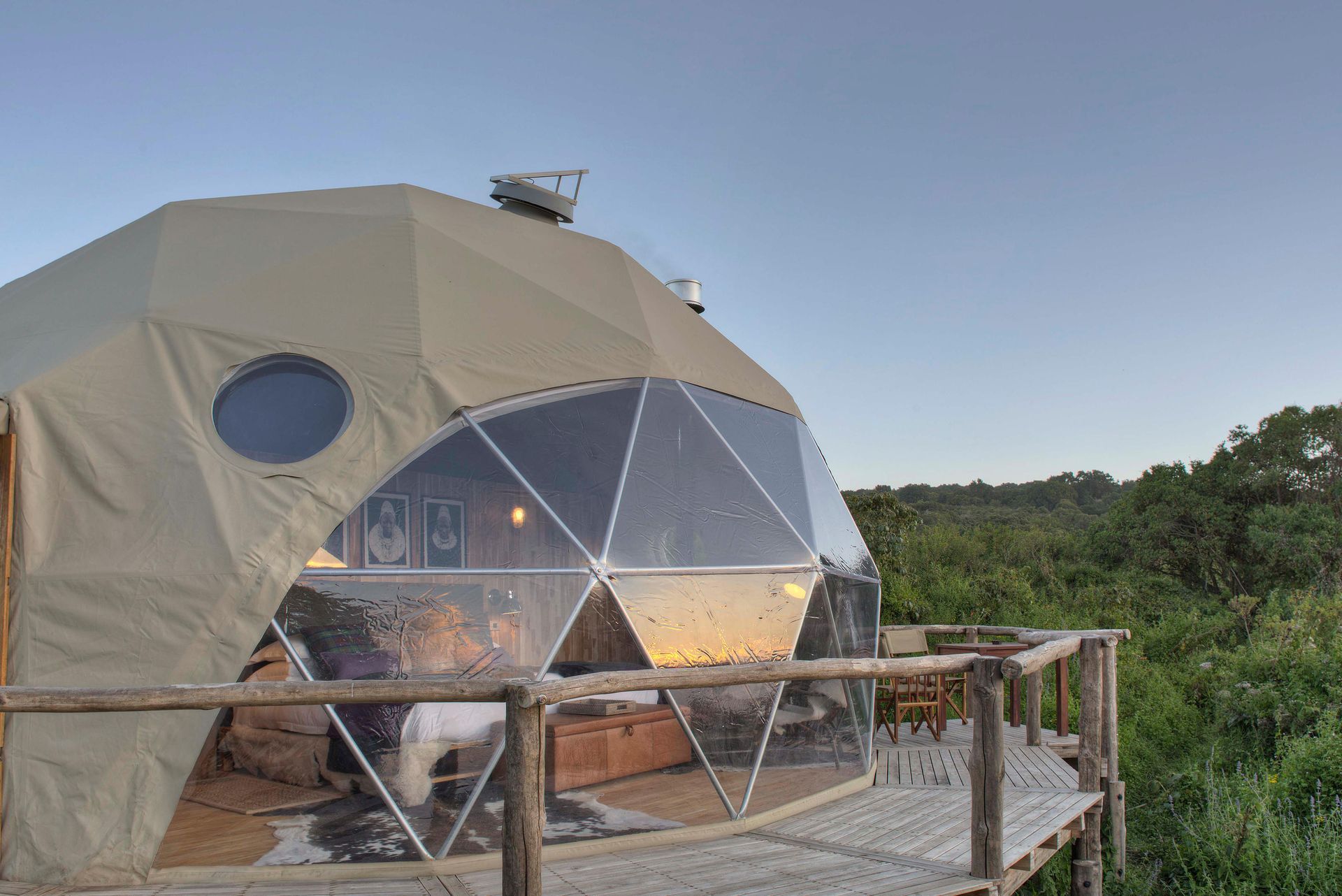 A dome tent is sitting on top of a wooden deck the Highlands Ngorongoro Crater