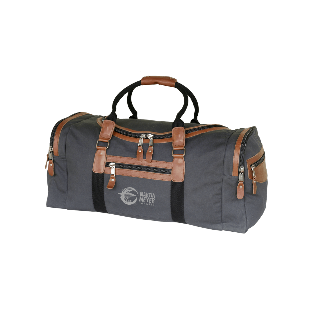 Tan duffel bag with brown leather trim and handles.