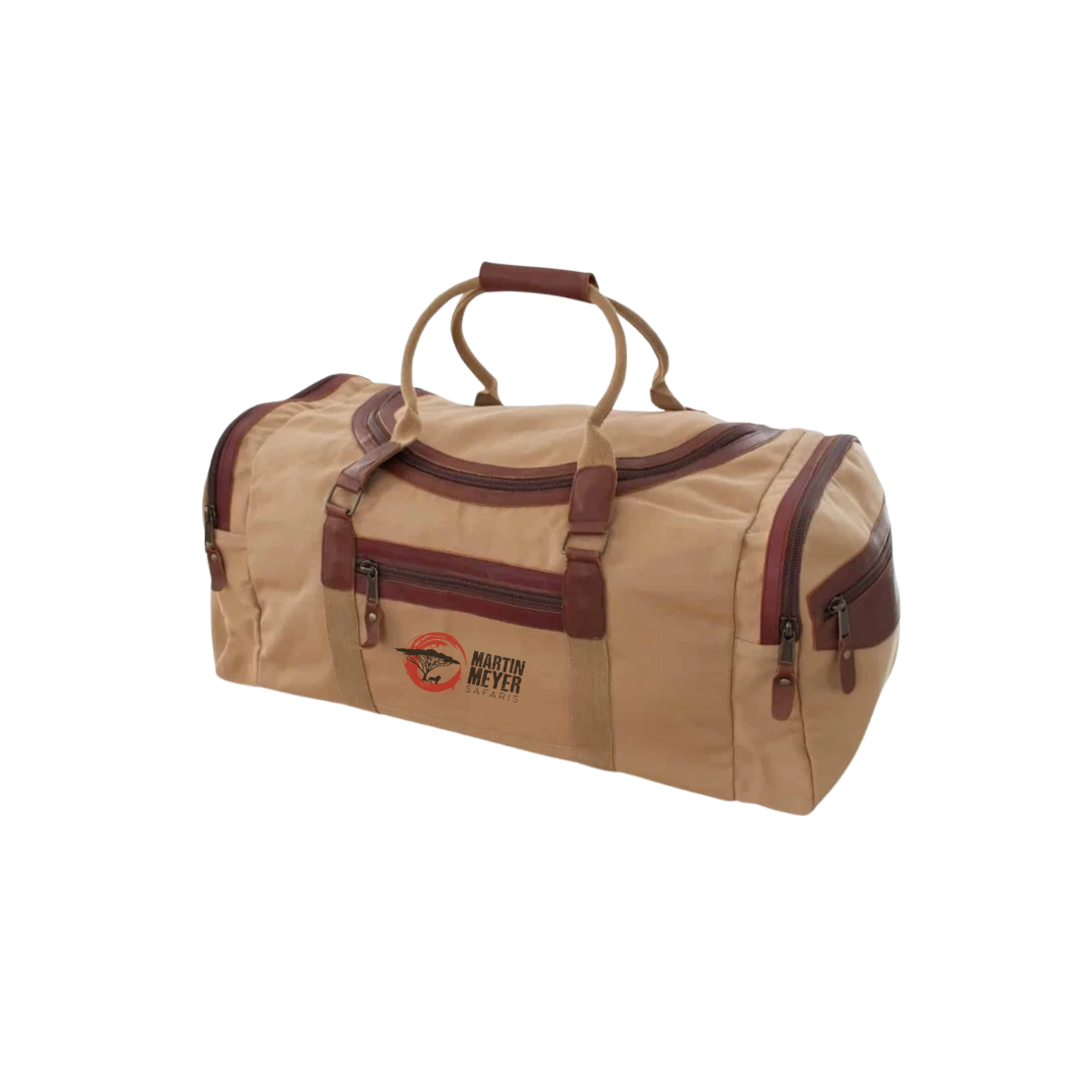 Tan duffel bag with brown leather trim and handles.