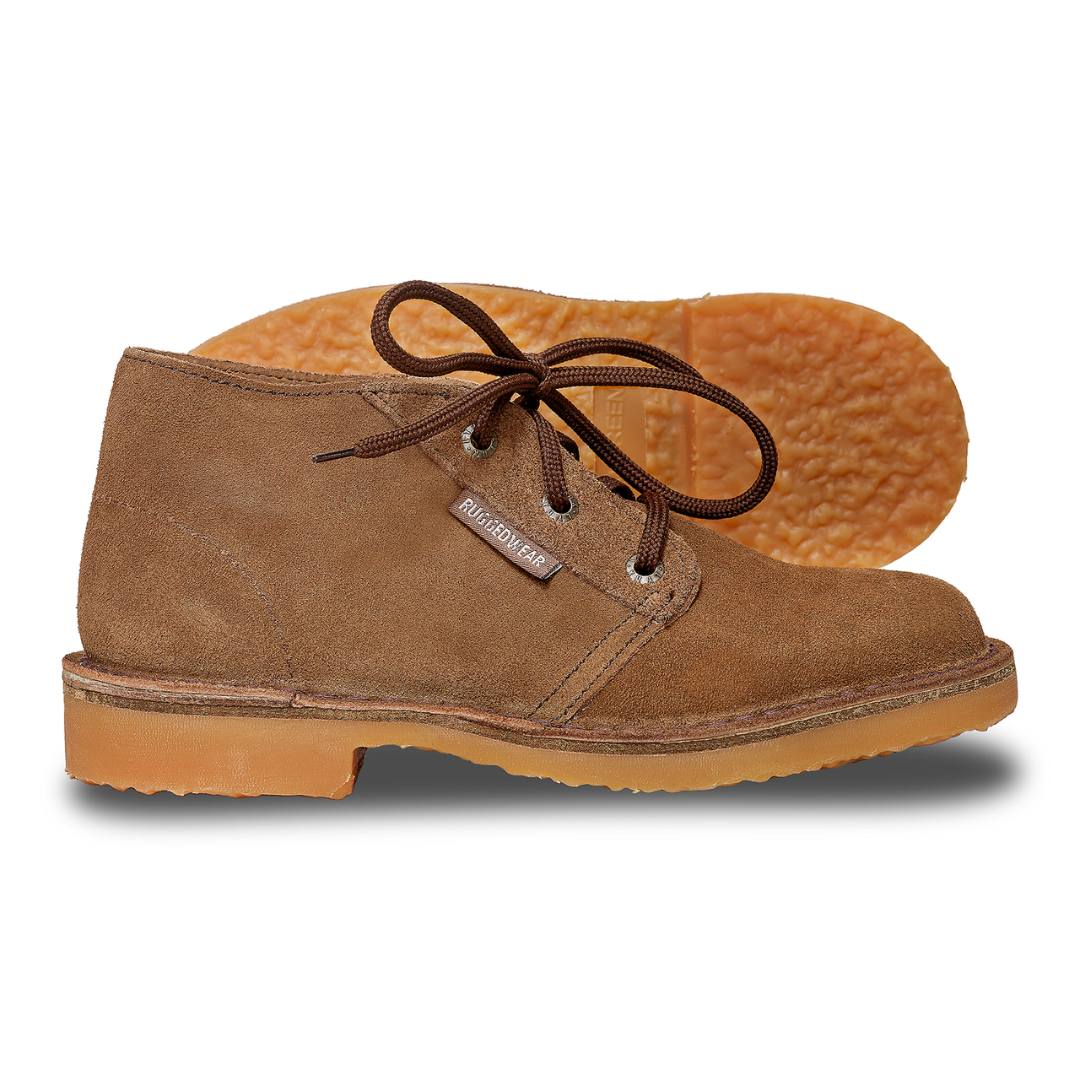 Brown suede chukka boot with matching laces, a rubber sole, and the sole of a second boot visible in the background.