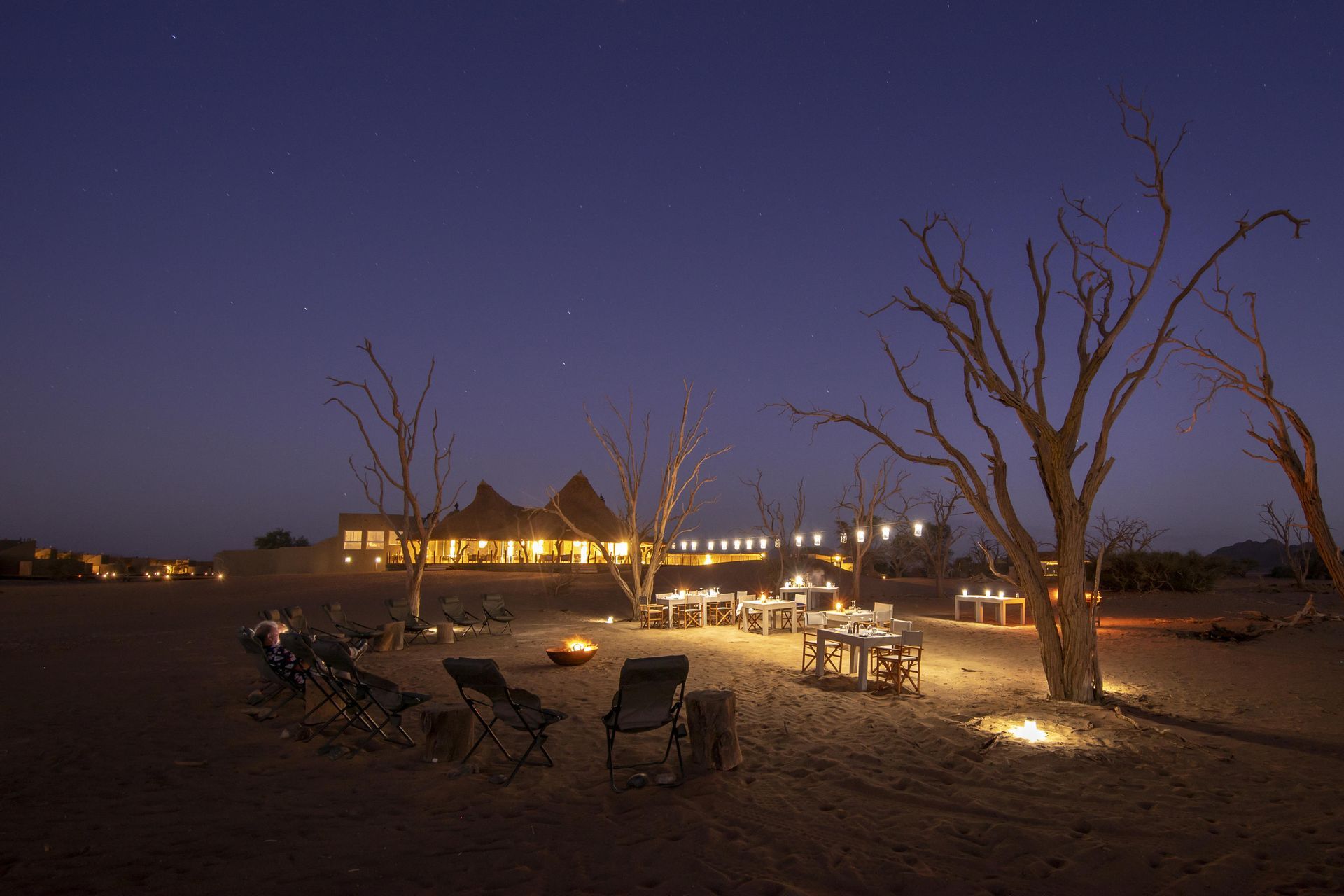 A group of chairs and tables in the desert at night Namibia Safari