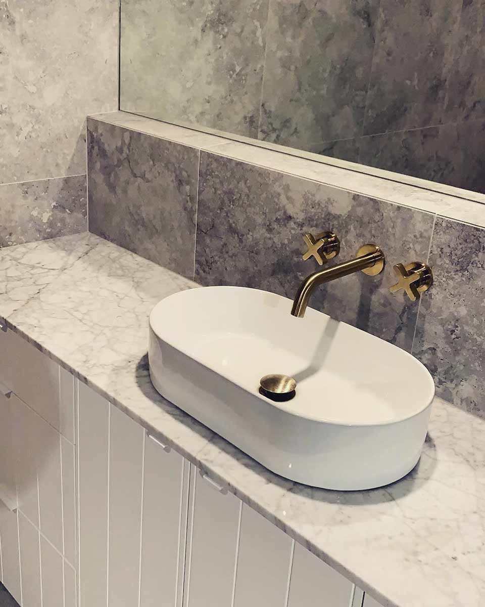 A Bathroom Sink With A Marble Counter Top And A Mirror — Todd Williams Plumbing and Gas Fitting In Forster, NSW