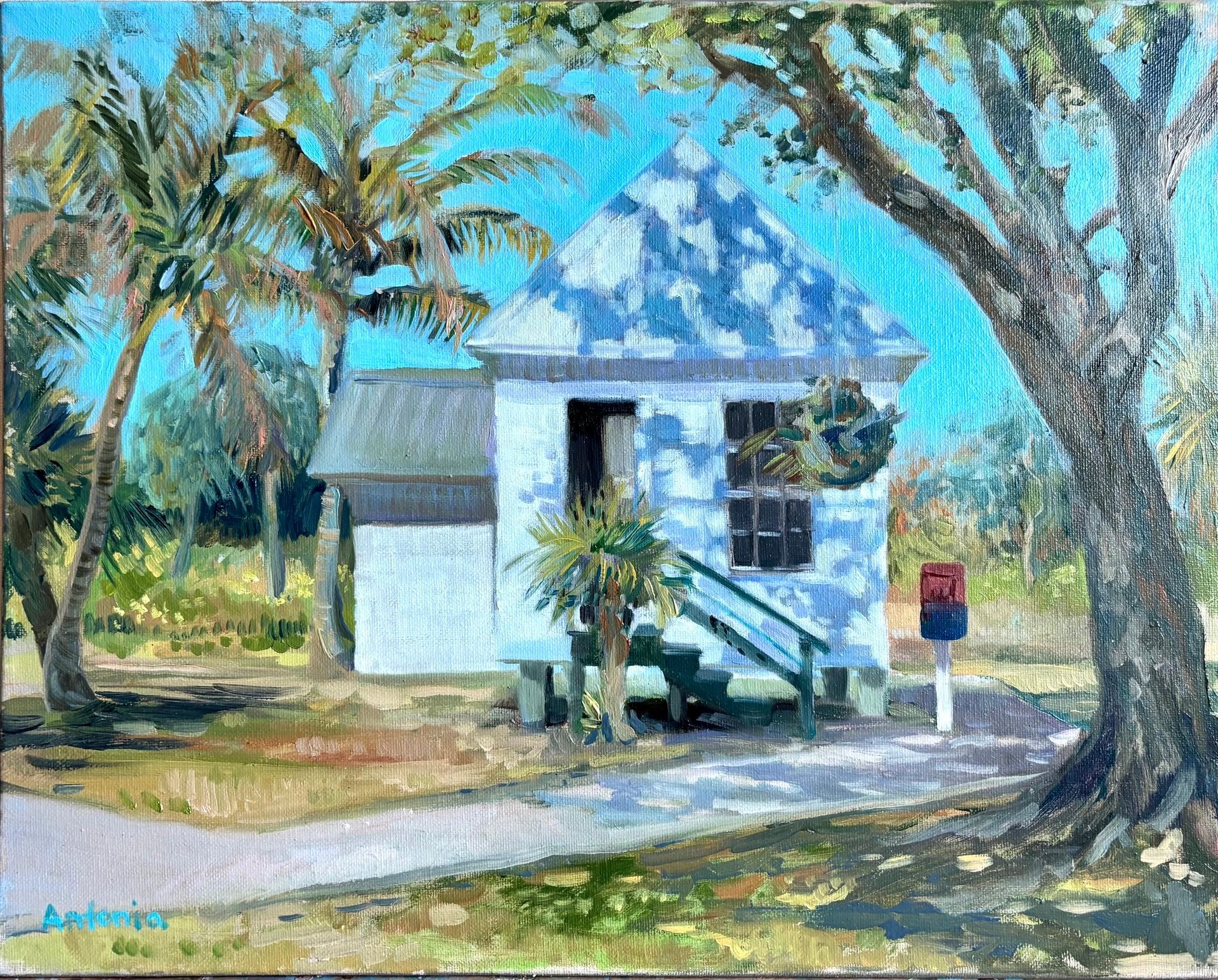 Blue house with blue roof and dormers. Overgrown greenery, flowers to the right.