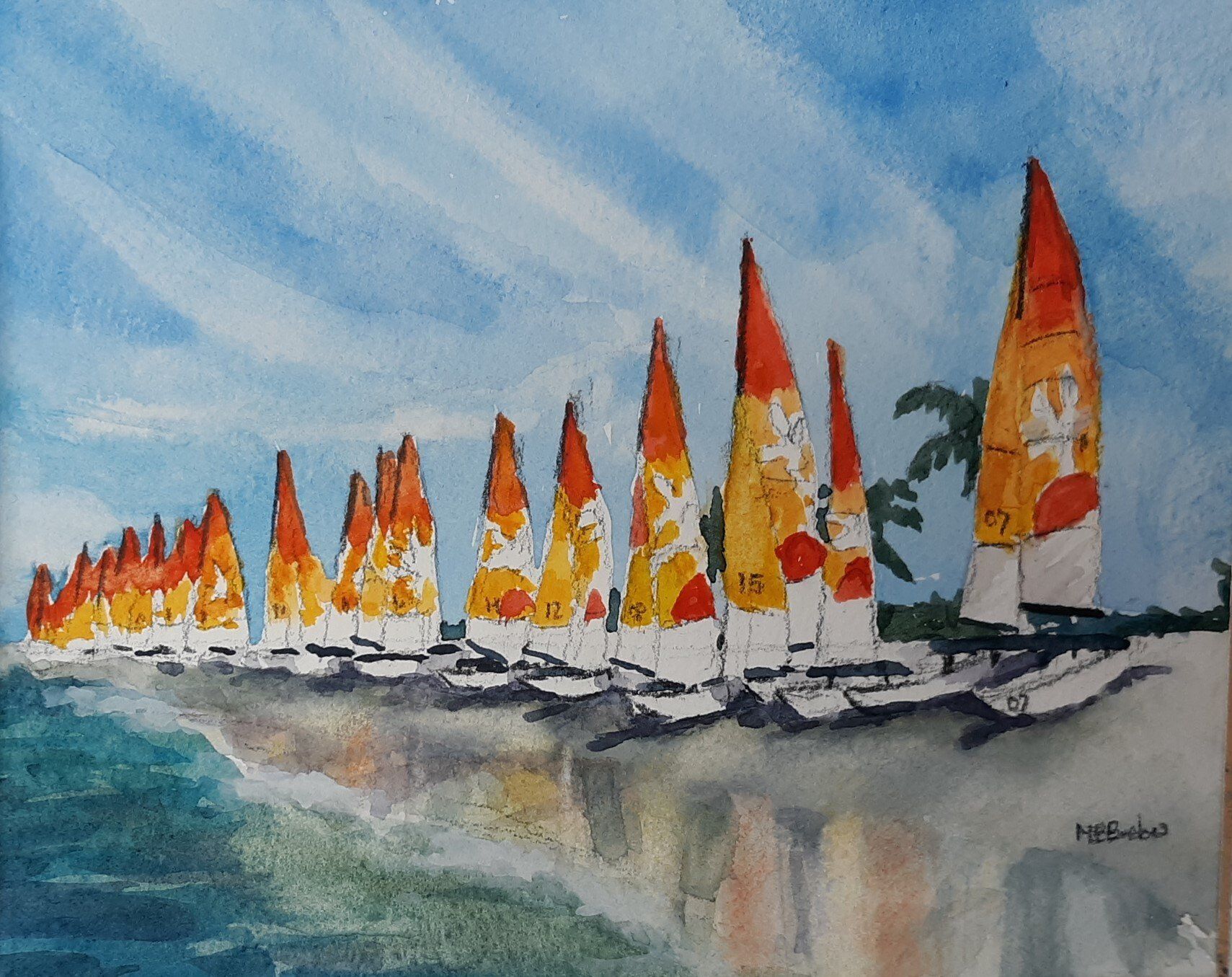 Row of colorful sailboats on a beach, under a bright blue sky.