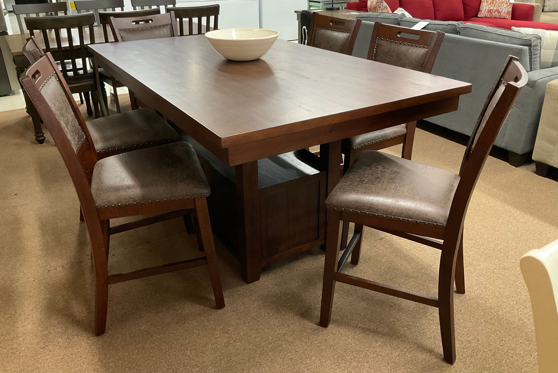 New dining table with four chairs, all in dark brown wood with light brown seat cushions.