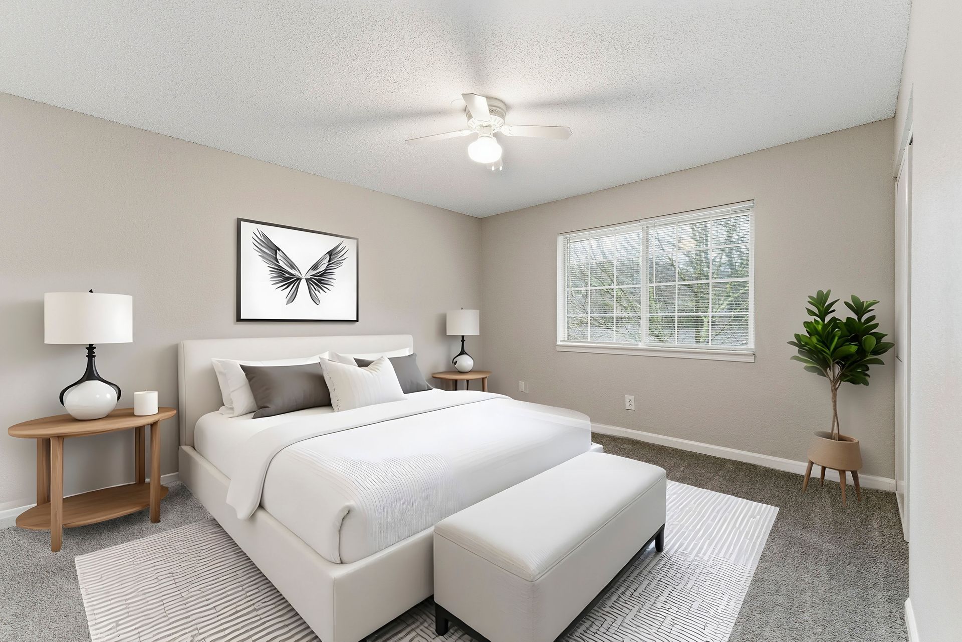 Bright modern bedroom with white bedding, gray rug, butterfly wall art, lamps, and a window with blinds