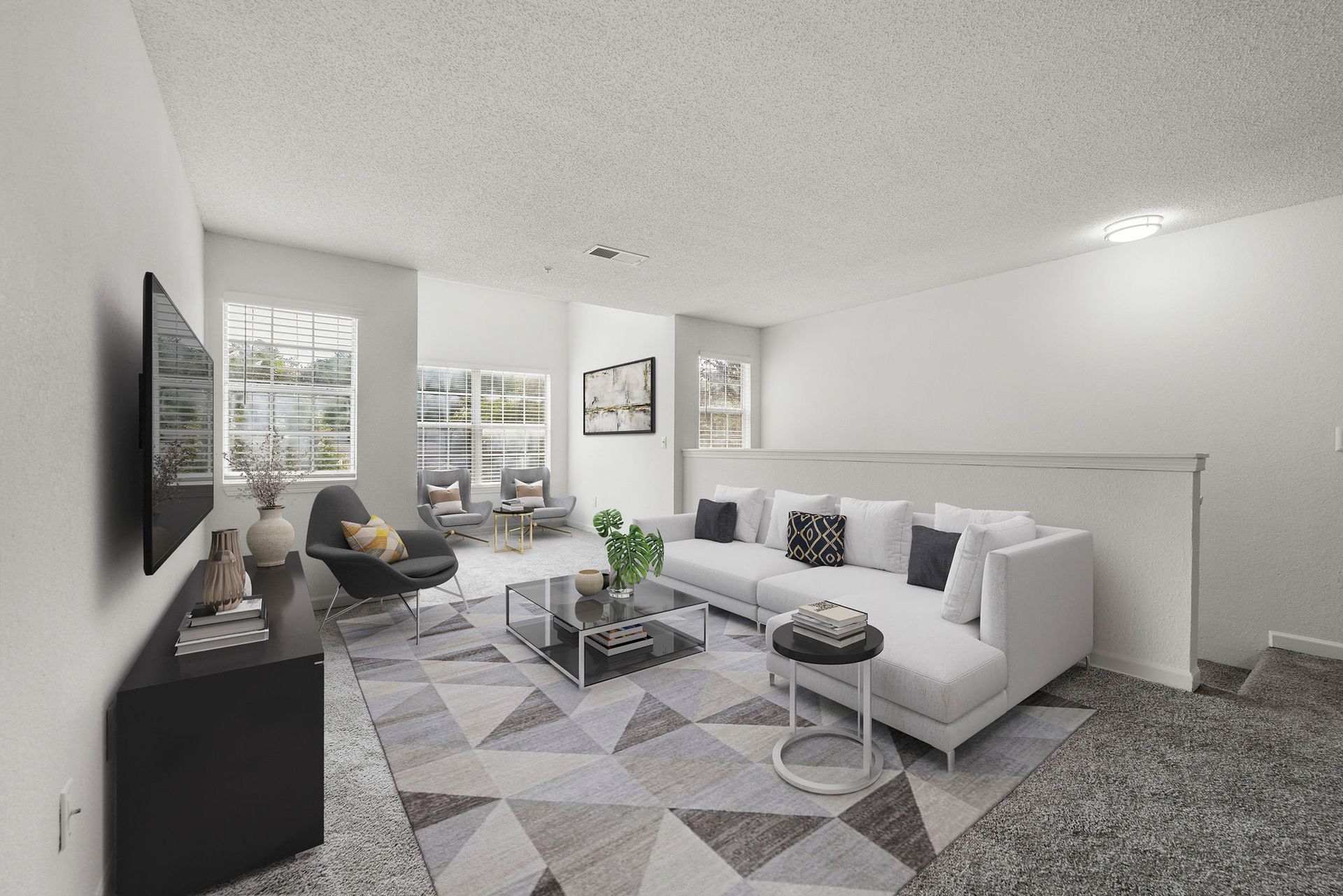 Bright modern living room with white sofa, patterned rug, TV, and large windows with city view