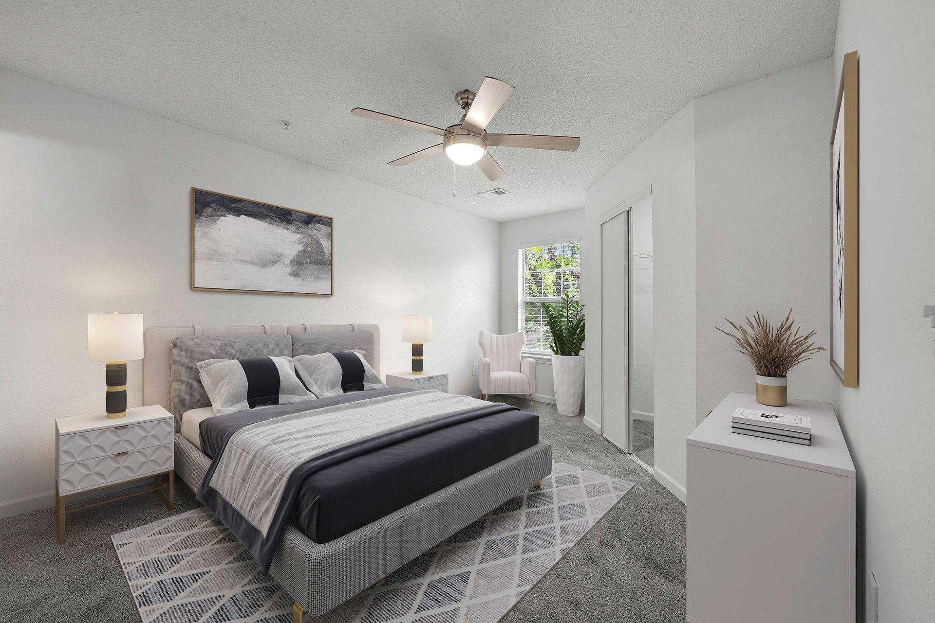 Bright modern bedroom with gray bedding, bedside lamps, ceiling fan, and balcony door