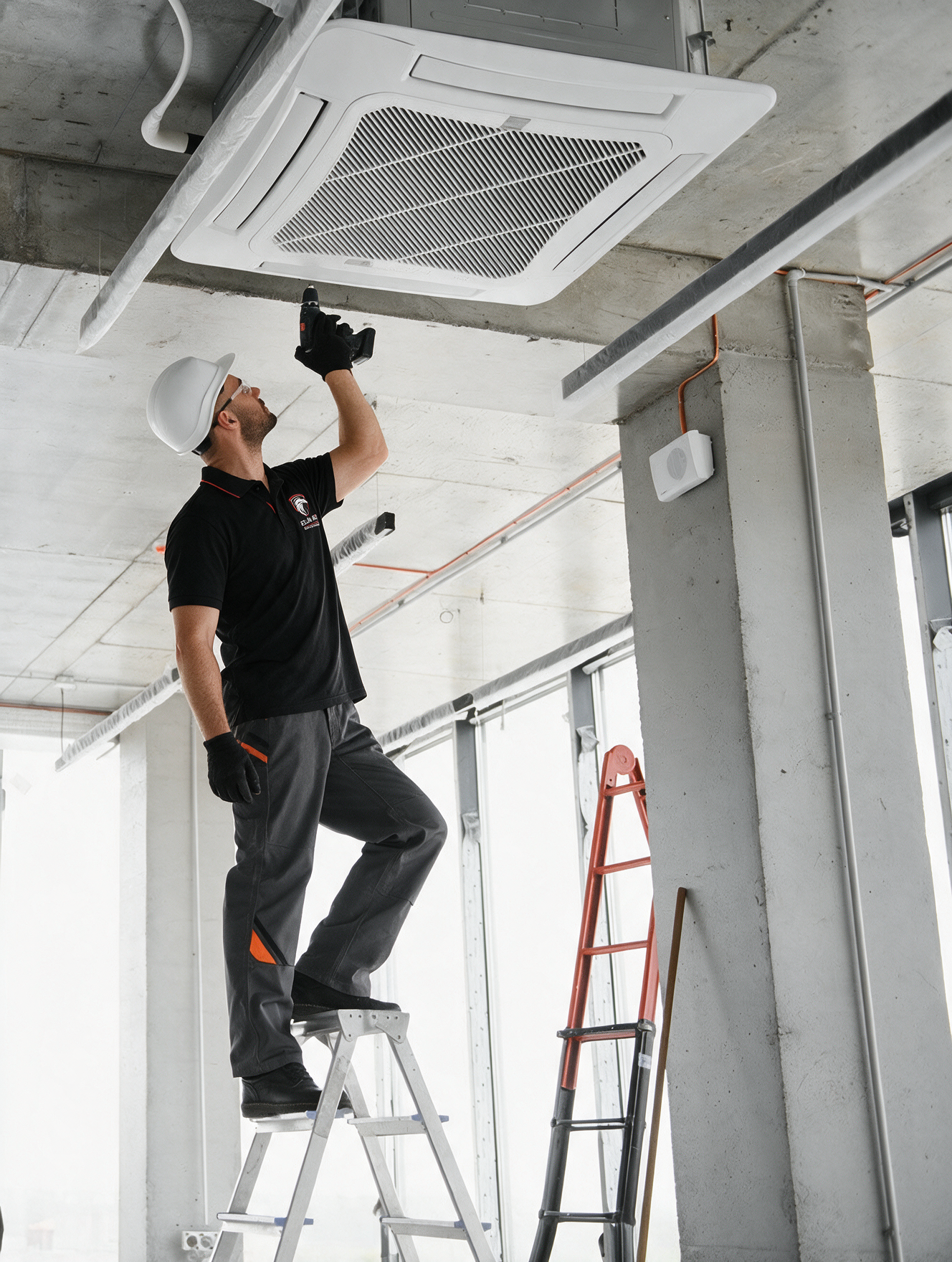 Worker on a ladder installing a ceiling air vent in an unfinished room.