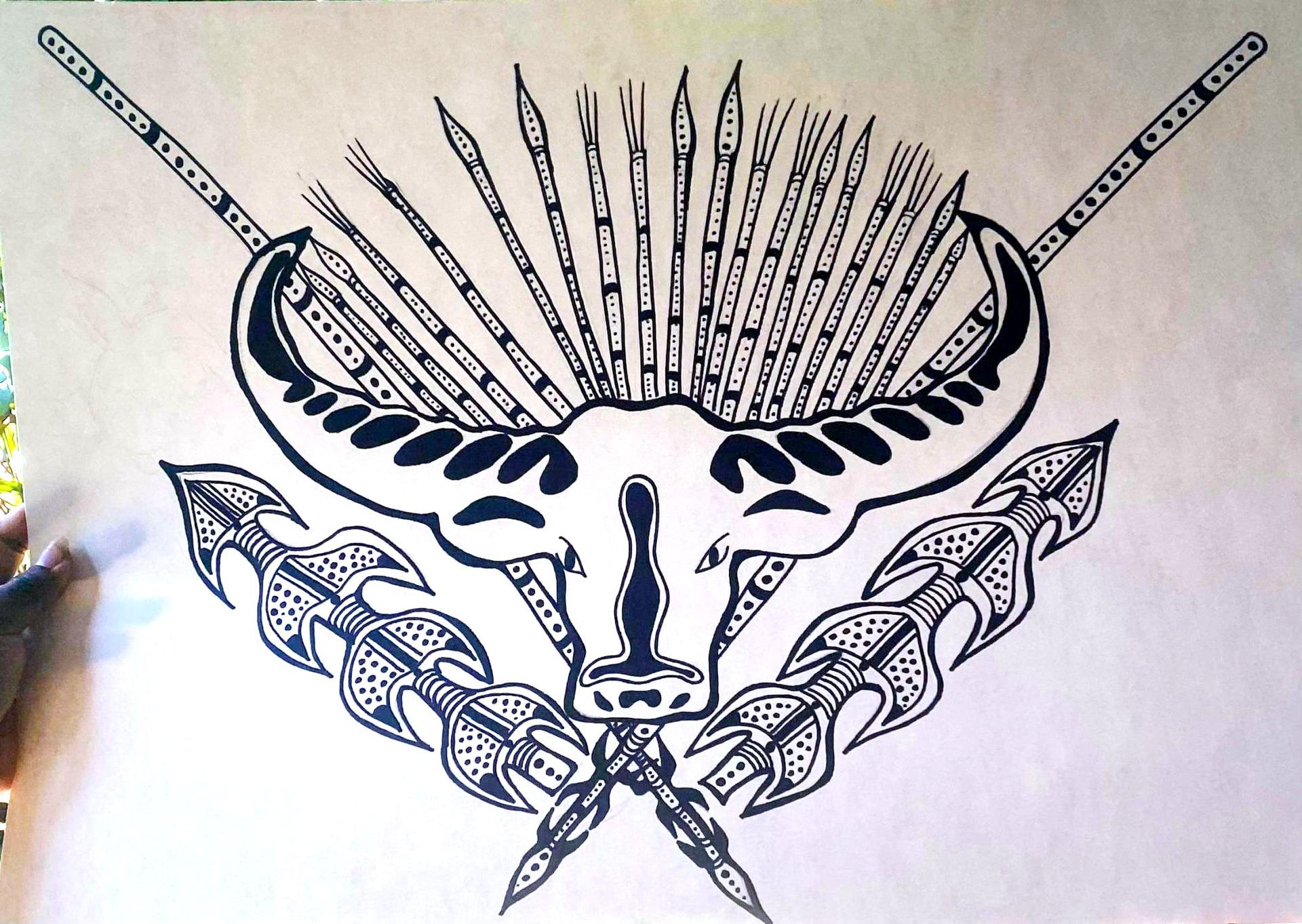 Black ink illustration of a bull skull with spears and feathers; looks like a crest or emblem.