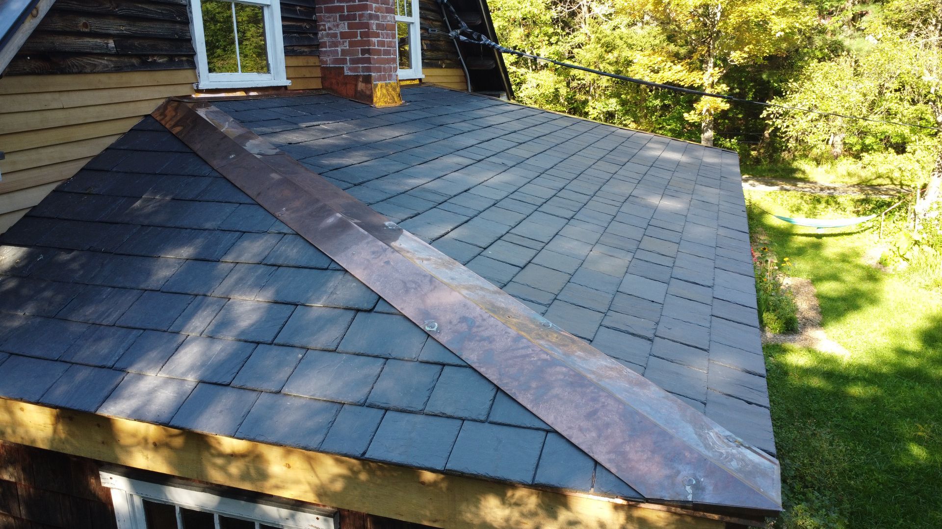 Black Slate Shingles from Greenstone Slate on porch using Slatetec system and copper flashing