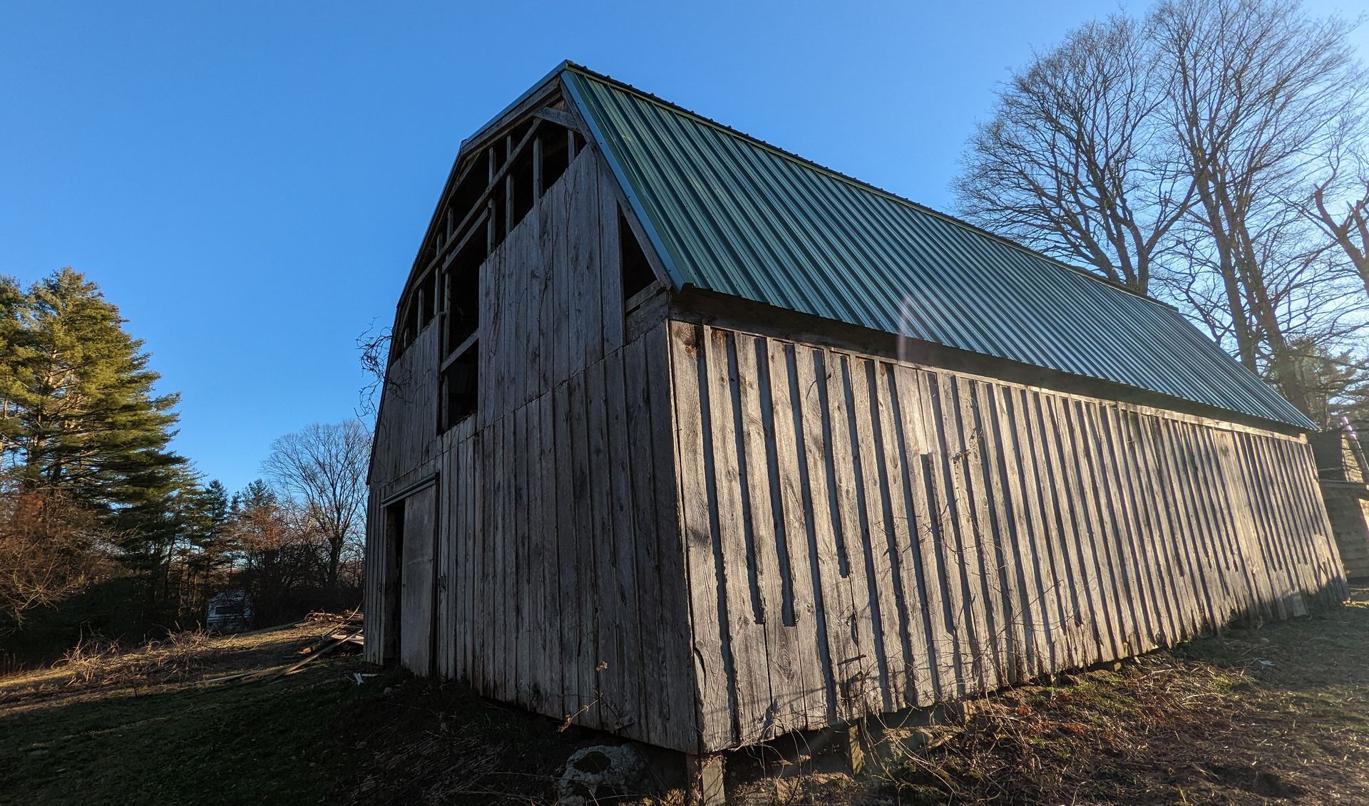 Exposed fastener metal roof installation on barn in Williamsburg MA