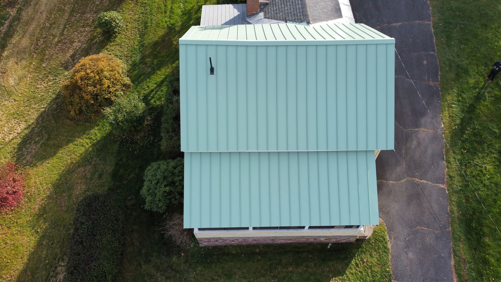 Patina green standing seam metal roof in Shelburne Falls MA