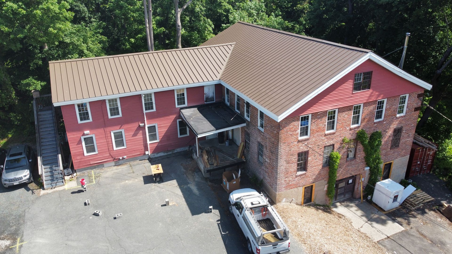 Standing seam metal roof installation on Roundabout Books in Greenfield, MA
