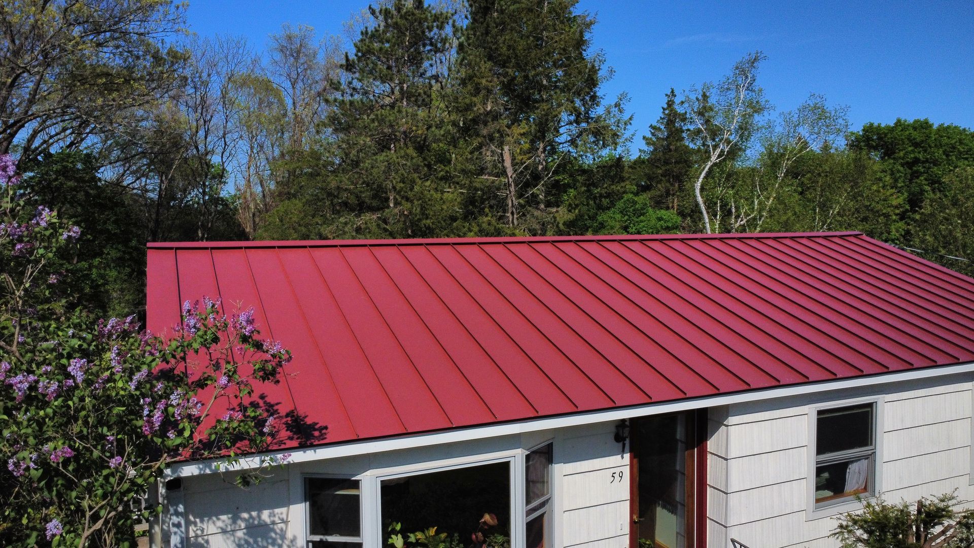Red standing seam metal roof in Amherst MA
