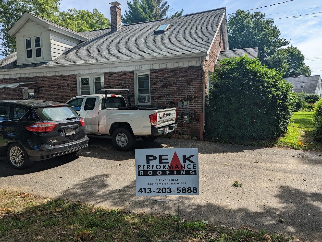 Peak Performance Roofing truck at asphalt shingle installation project