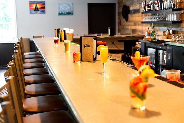 A long bar with a lot of drinks on it