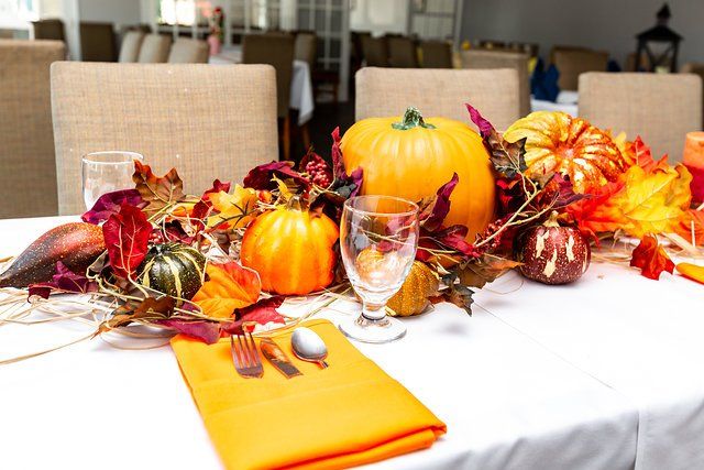 A table with pumpkins and leaves on it