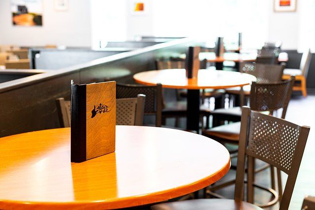A restaurant with tables and chairs and a menu on the table