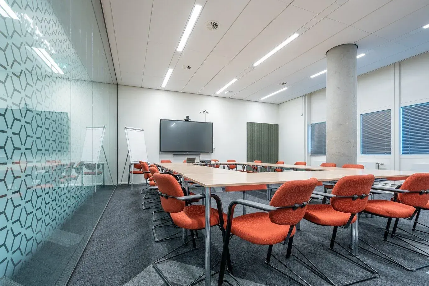 A conference room with tables and chairs and a flat screen tv in Los Angeles, CA