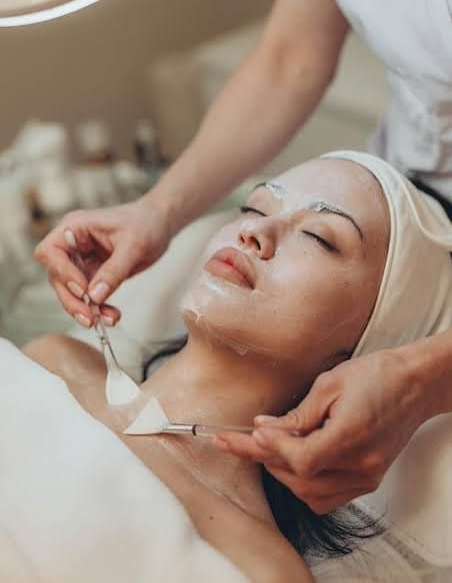 Therapist applying a facial treatment to a client