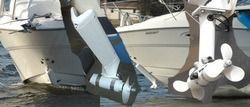 Two boats, one with a stern drive, the other with a pod drive in the water.
