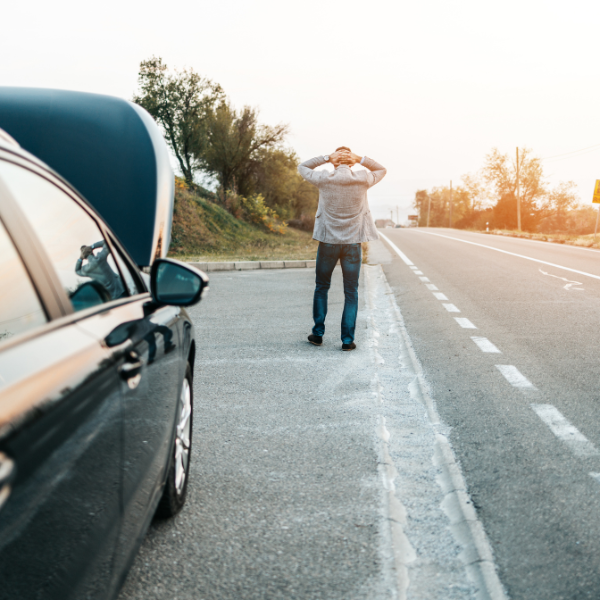 man experiencing car trouble on the side of the road