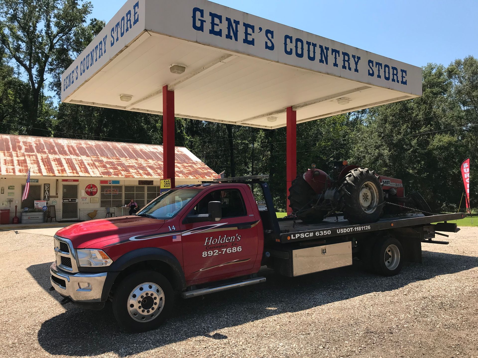 flat bed truck towing antique tractor