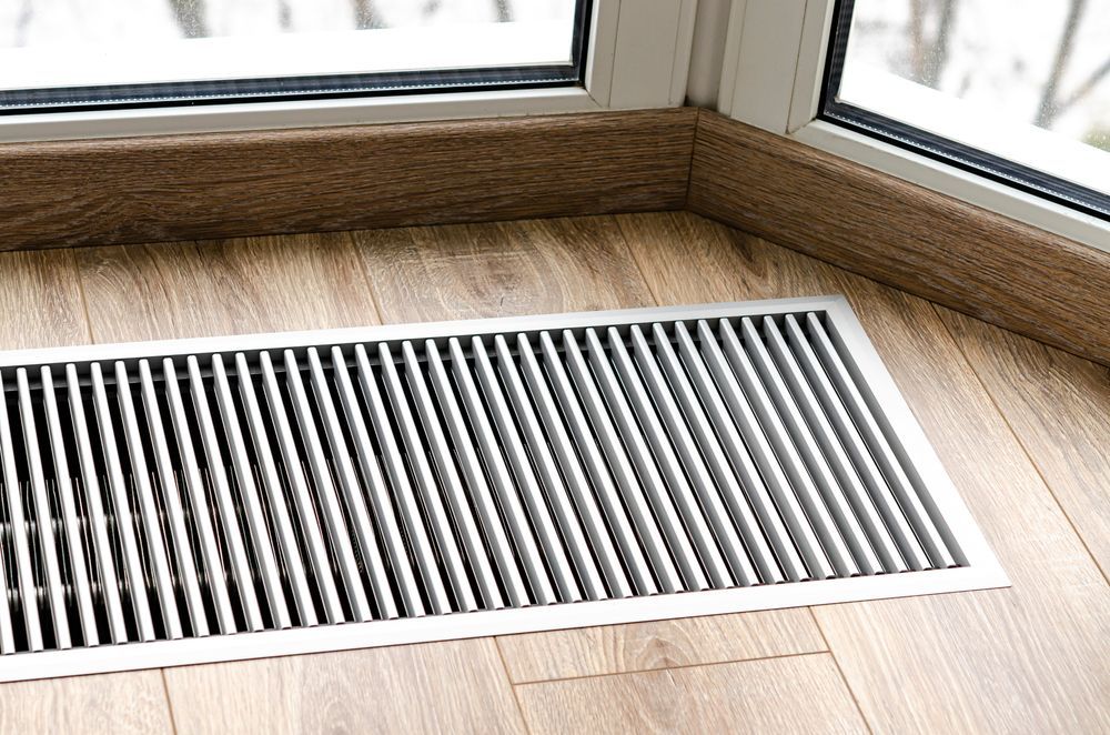 A Stainless Steel is Sitting on a Wooden Floor Next to a Window — Marshall Notaras Hardwoods Pty Ltd In Ballina, NSW