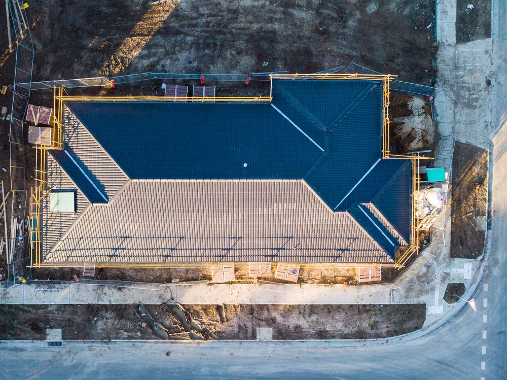An Aerial View of a Building Under Construction With a Blue Roof — Marshall Notaras Hardwoods Pty Ltd In Grafton, NSW