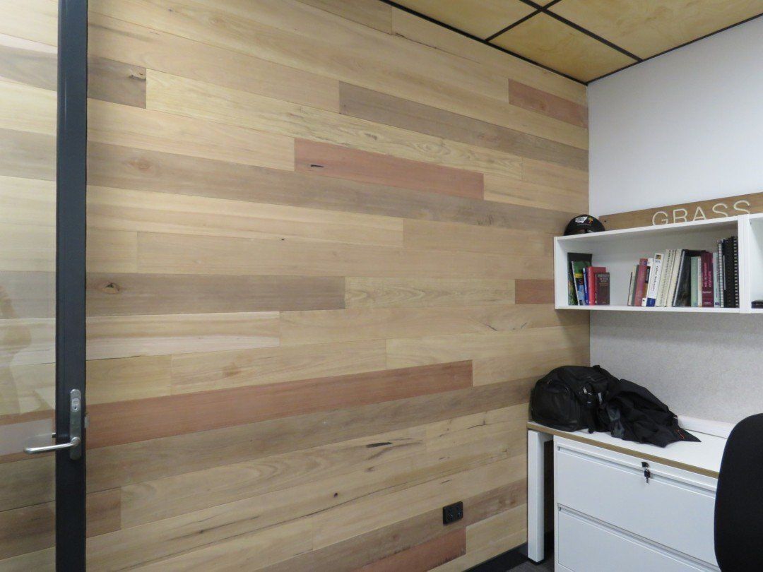 A Small Office With a Wooden Wall and a Desk — Marshall Notaras Hardwoods Pty Ltd In Gold Coast, QLD